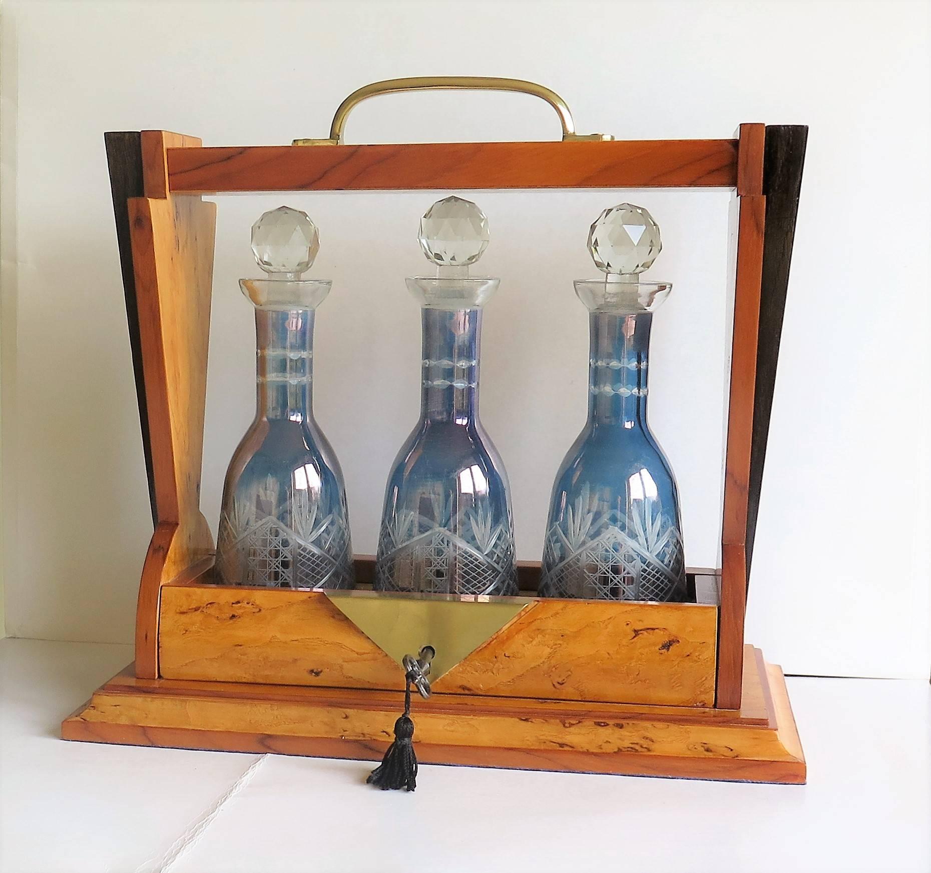 This is a beautiful Tantalus with THREE blue glass engraved decanters from the Art Deco period, probably made in France.

The Tantalus frame is beautifully designed and made, in the geometric shape and lines which so epitomises the Art Deco period.
