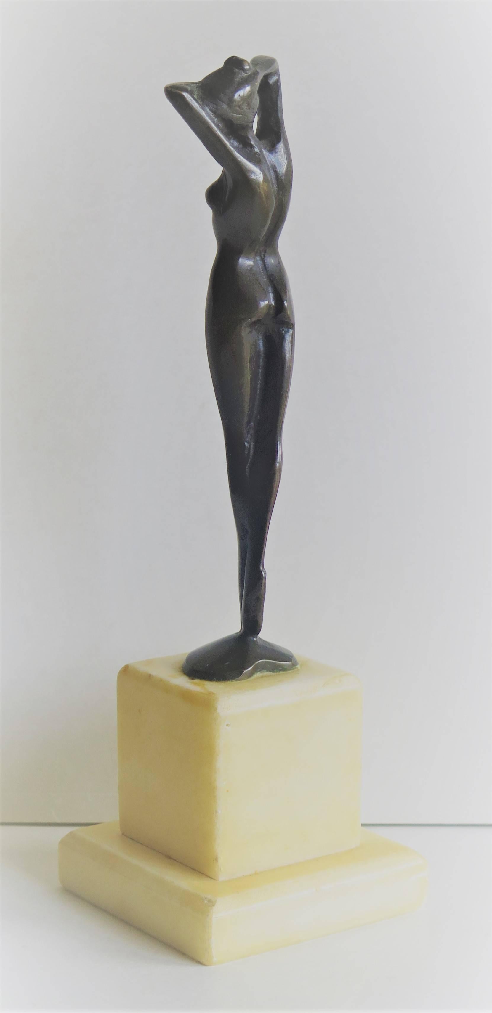 This is a solid bronze figurine of a nude lady.

The figure is beautifully sculpted in the style of Josef Lorenzl - see below - with the long limbed female form typical of Lorenzl and the Art Deco period generally. The circular bronze base of the