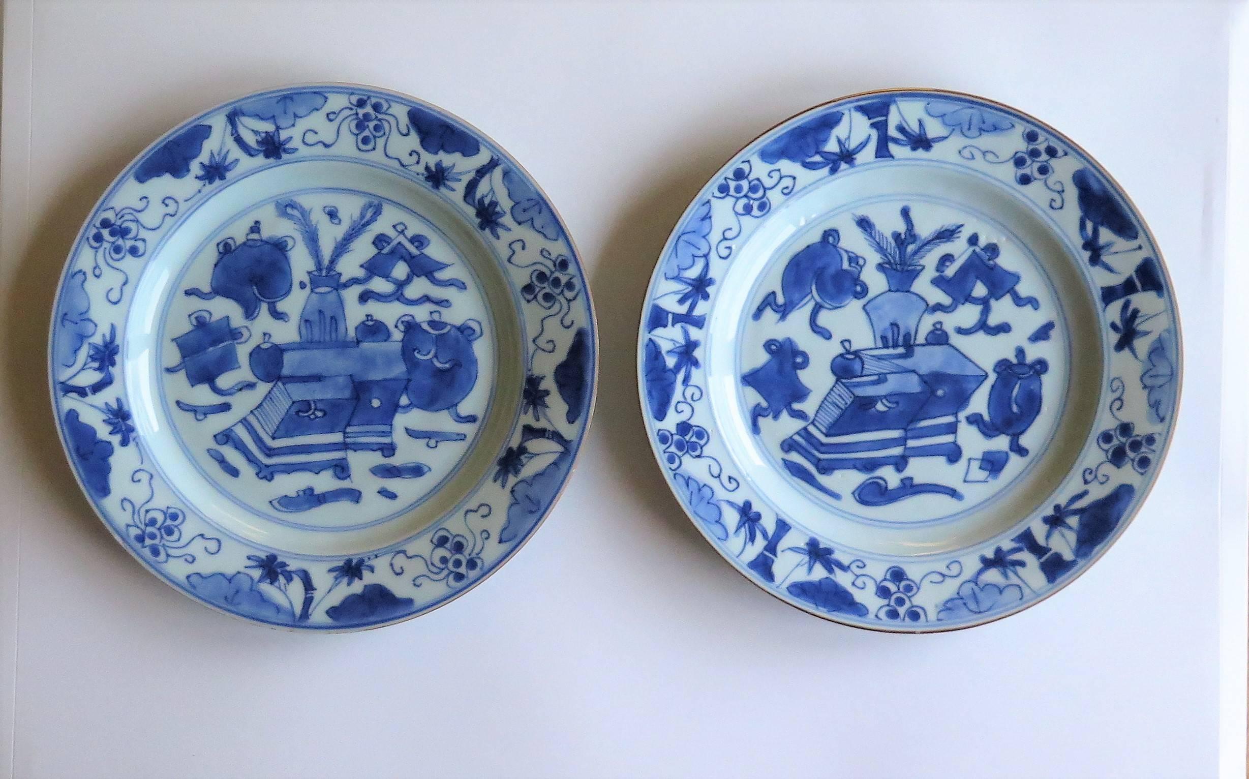 These are a beautiful hand-painted pair of Chinese porcelain plates, dating to the early / mid-18th century, circa 1720-1750, Qing dynasty.

The plates are well potted, and have been hand decorated in varying shades of cobalt blue. The glaze is thin