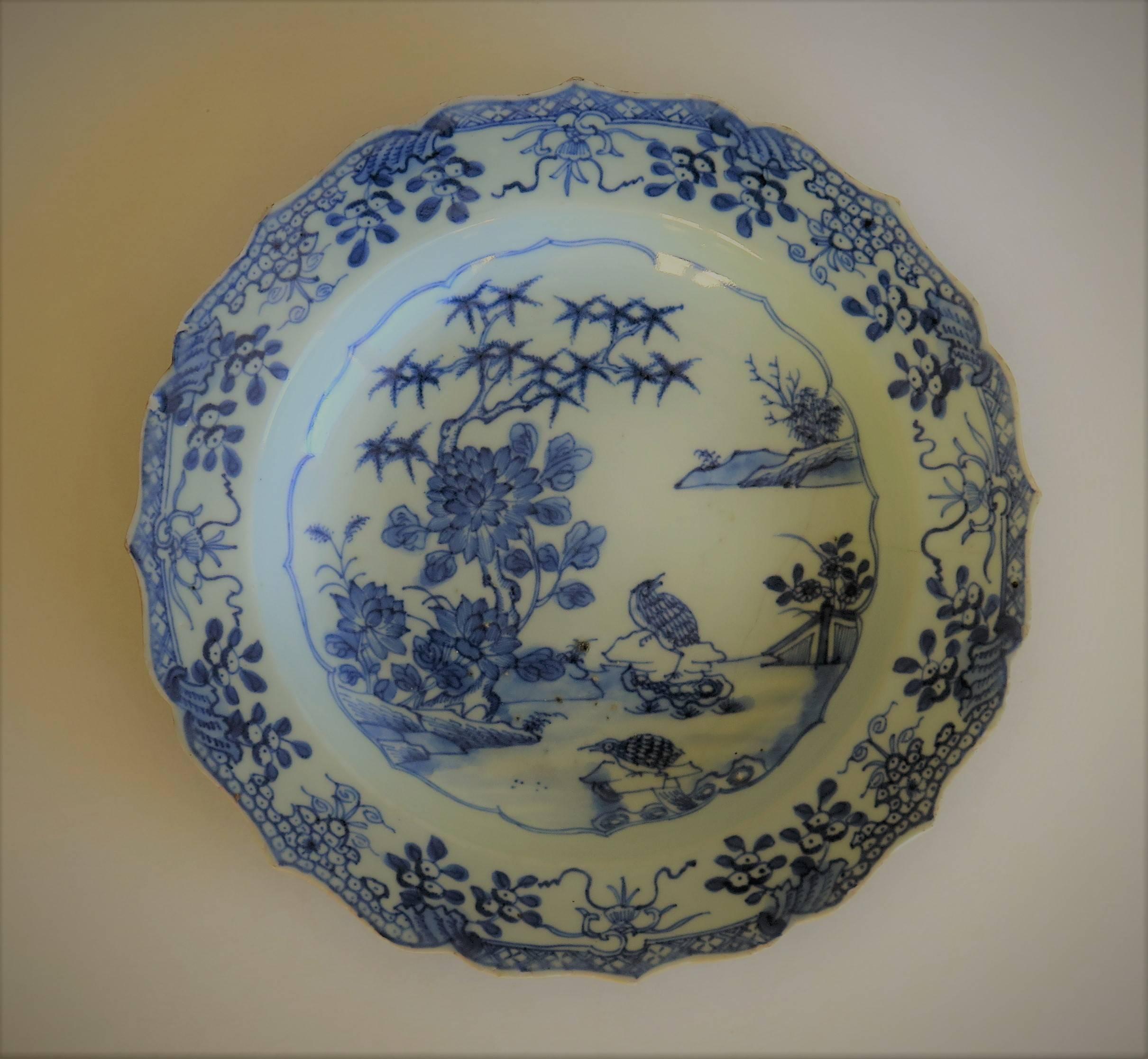 This is a good Chinese porcelain bowl or plate made for the export (Canton) market, during the second half of the 18th century.

The plate is circular with a nice scalloped edge and well decorated in varying shades of cobalt blue, with a glaze of