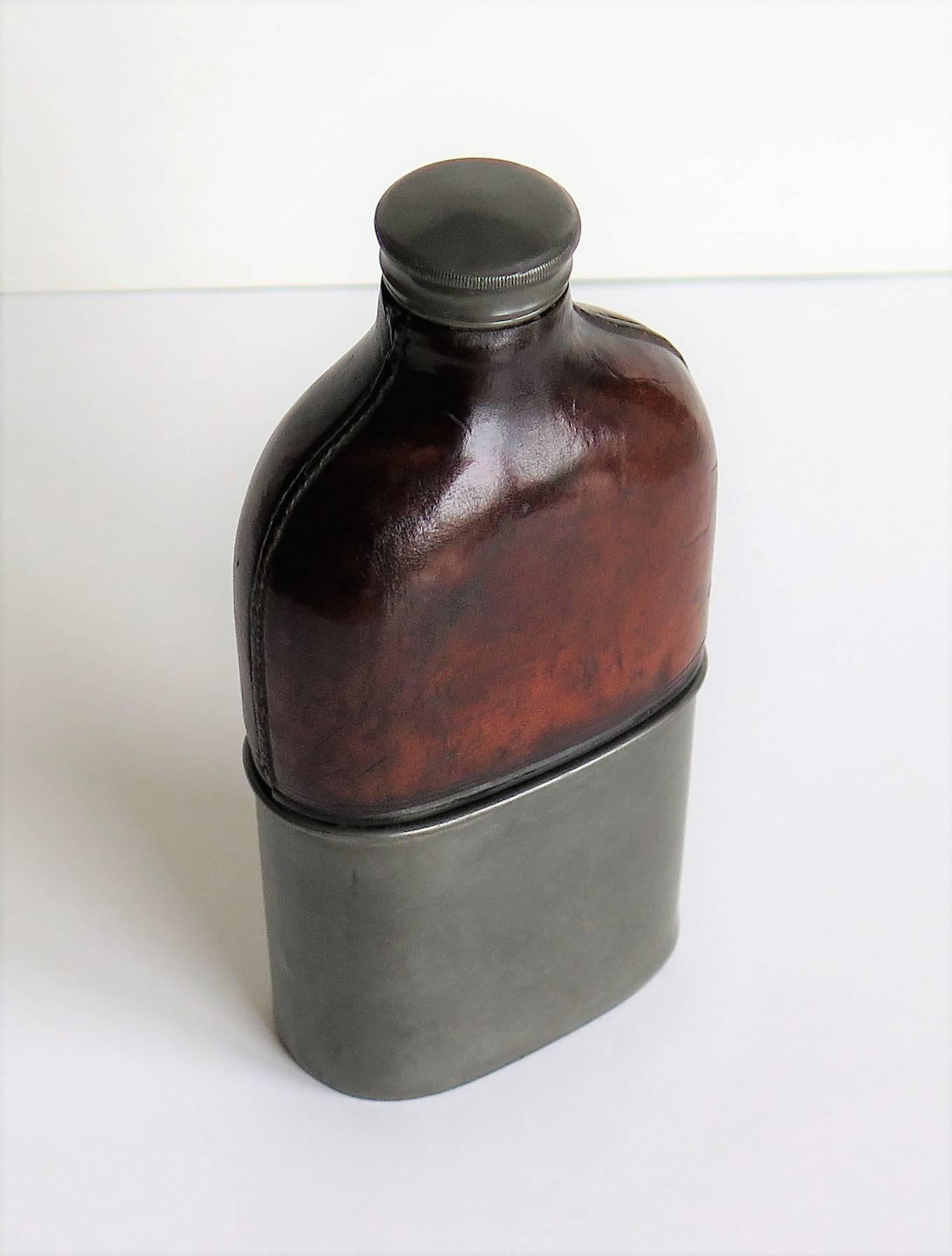 glass and leather hip flask
