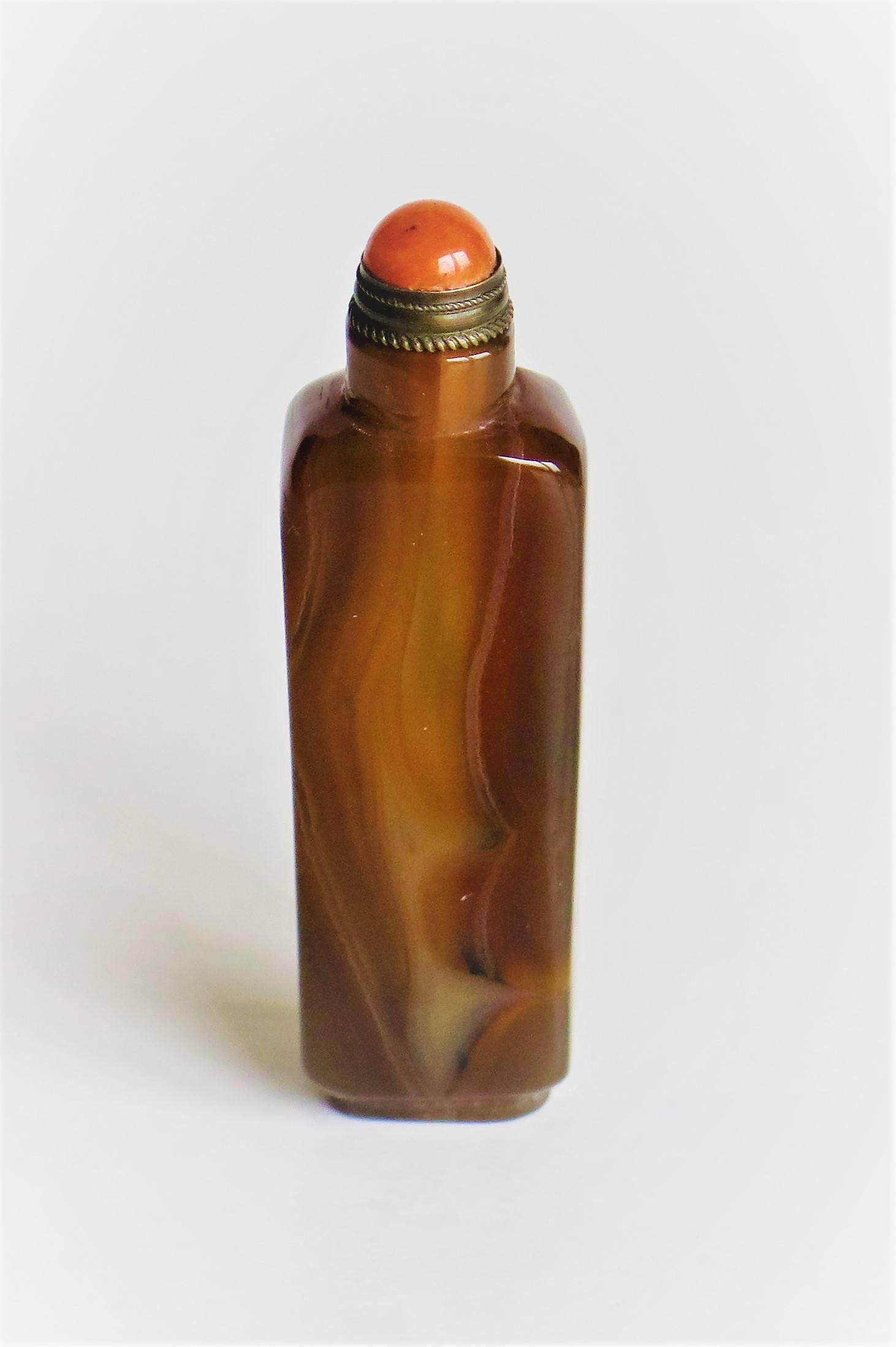 This is a good and very decorative Chinese snuff bottle from the 20th century, circa 1930.

The bottle is made of hand-carved and polished natural Jade. This Jade has an excellent natural veined texture of subtle coloring with colors of toffee /