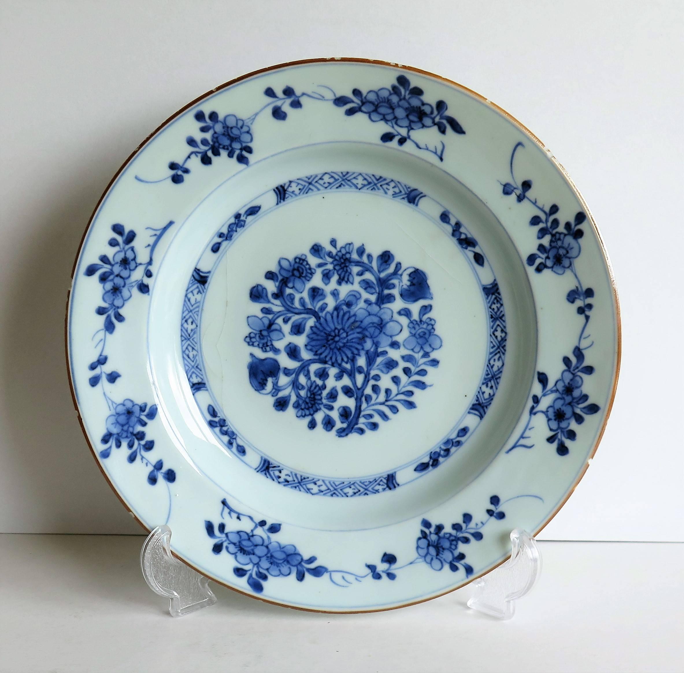 This is a beautifully hand-painted Chinese porcelain plate from the first half of the 18th century, Qing period, circa 1735.

The plate is finely potted with a carefully cut base rim and a lovely rich glassy, glaze with has a very light shade of