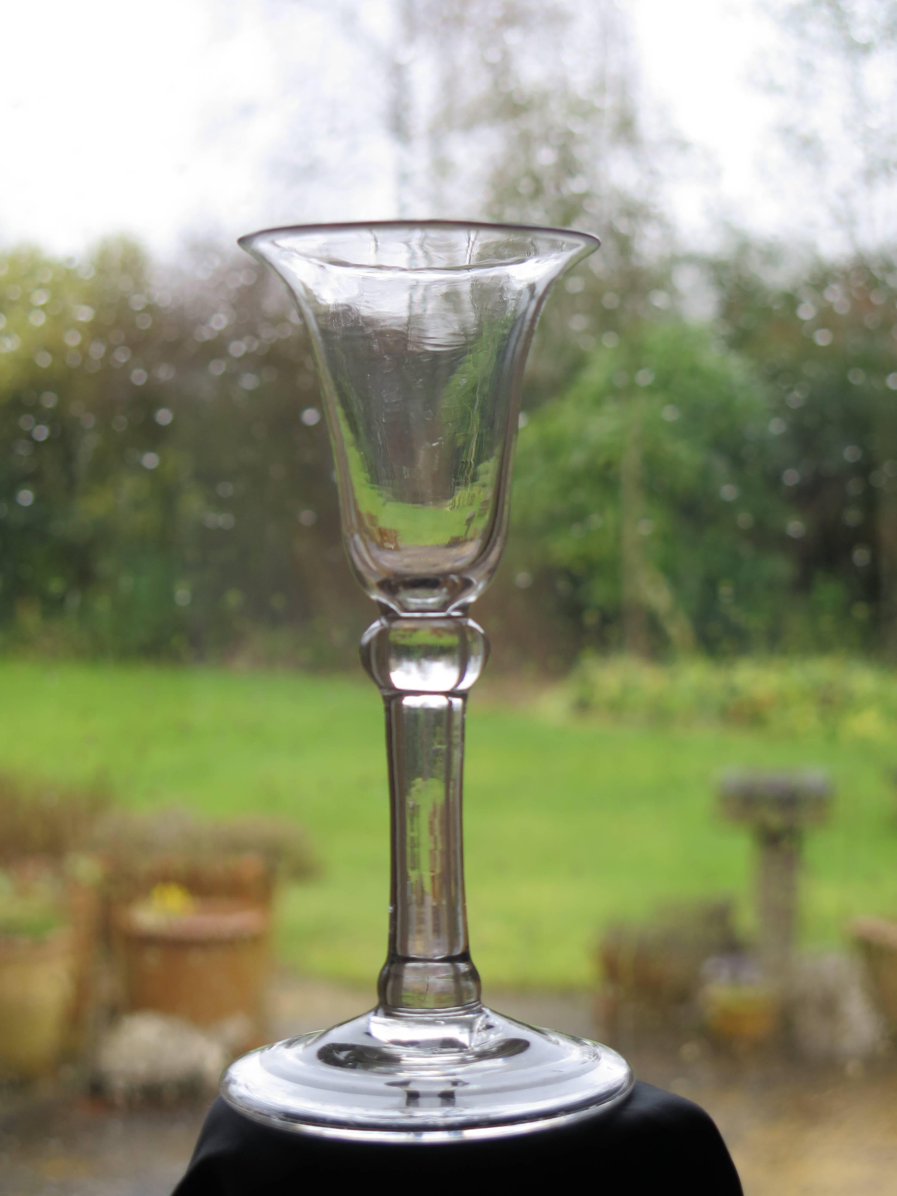 This is a good handblown, English, Georgian, 'Balustroid' wine drinking glass, dating from the middle of the 18th century, George XI period, circa 1740.

It is made from English lead glass which is relatively heavy and has a soft grey colour.

The