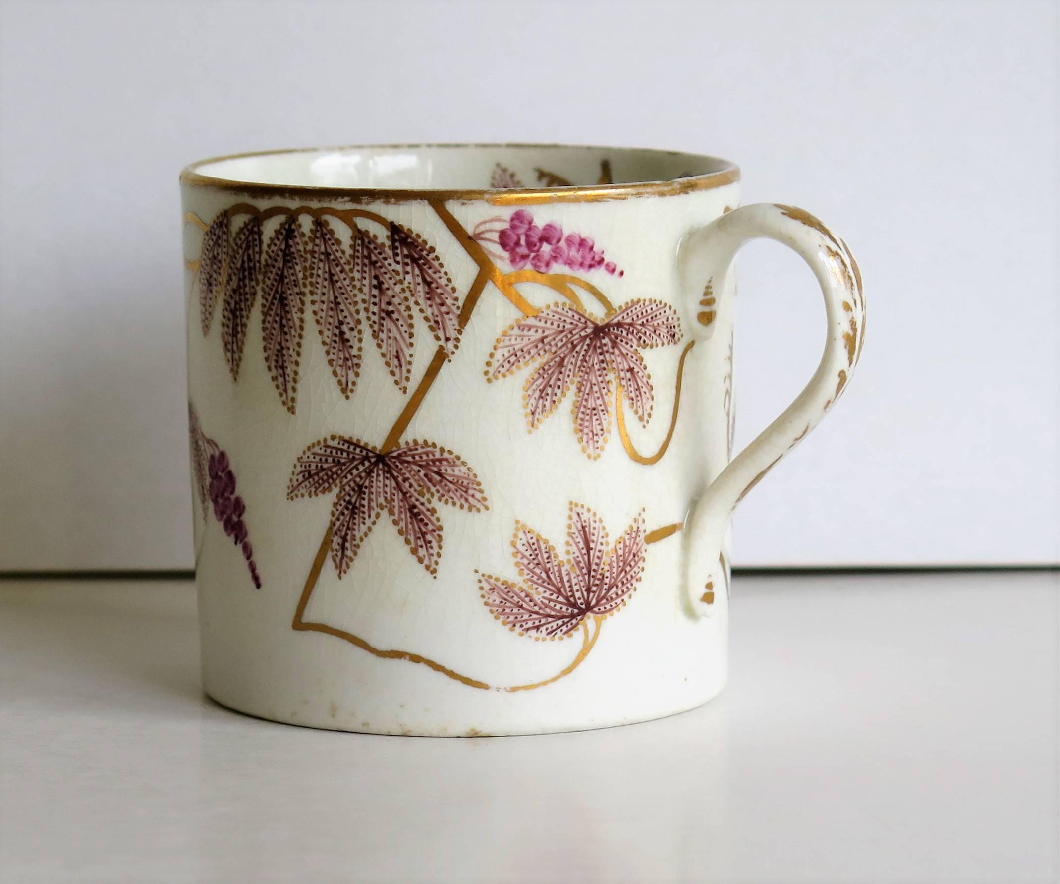 This is a beautifully hand-painted English coffee can, from the late George III period, of the very early 19th century, circa 1805.

This coffee can is nominally straight sided with a plain loop handle having pointed attachments.

The pattern