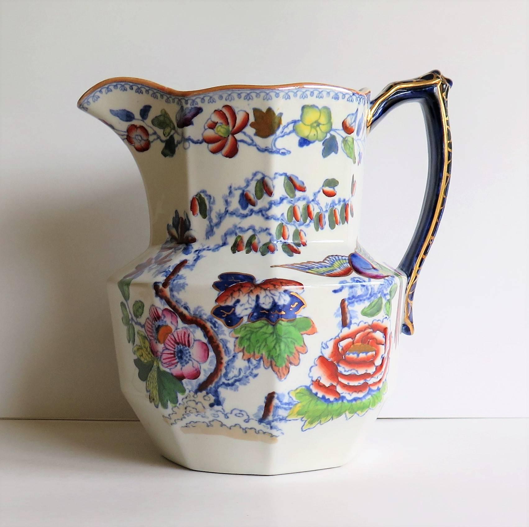 This is a very good large size hydra jug or pitcher by Mason's Ironstone, England, which we date to the late 19th Century Ca 1900. 

The Jug is octagonal in shape with an angular loop handle and impressive size of nominally 9 inches high. Large