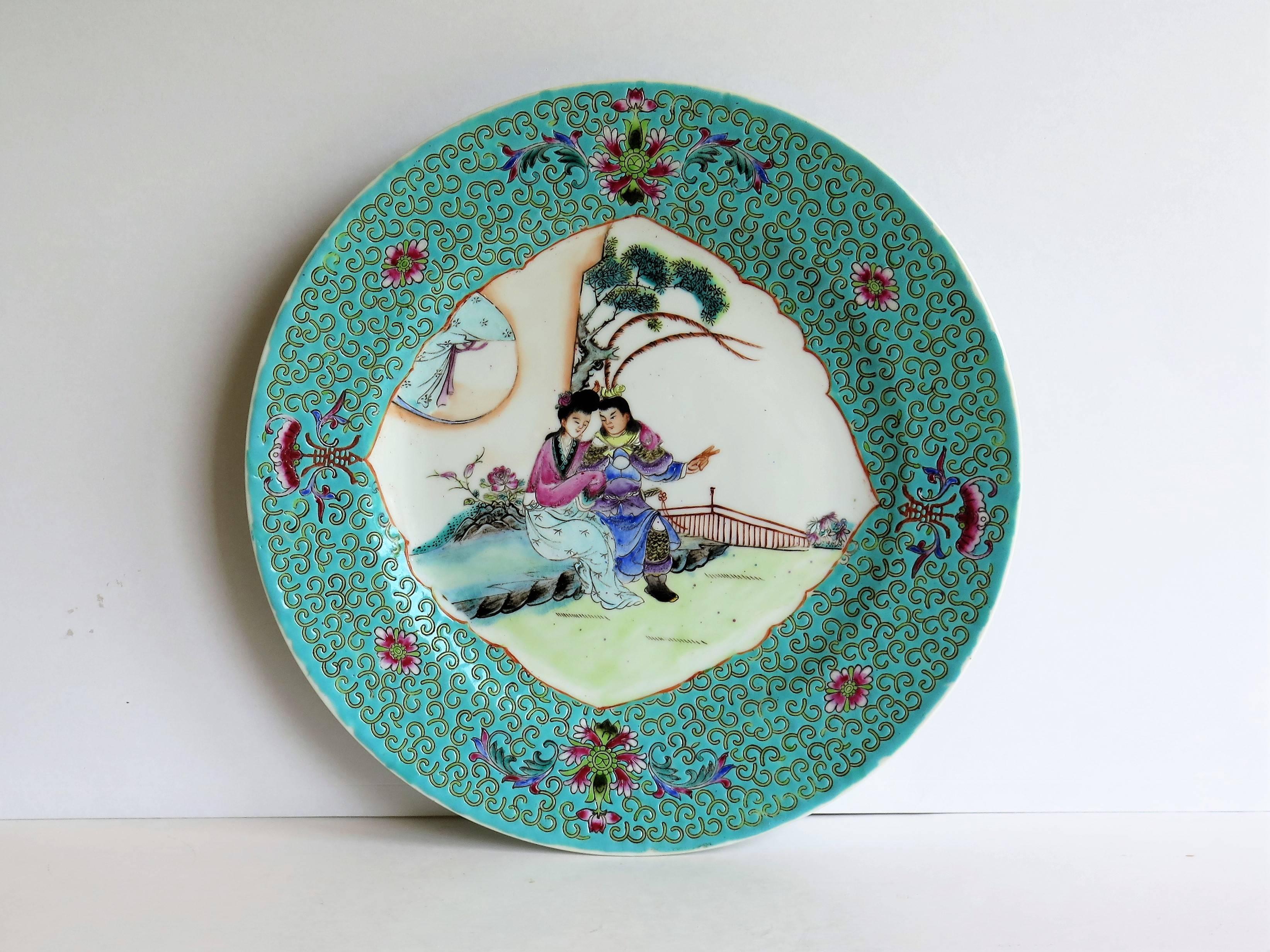 This is a good Chinese Export porcelain Plate which has been beautifully hand enamelled, over-glaze, in the Famille Rose palette with excellent detail, dating to Circa 1940.

The main design is framed within a central cartouche and shows a man and