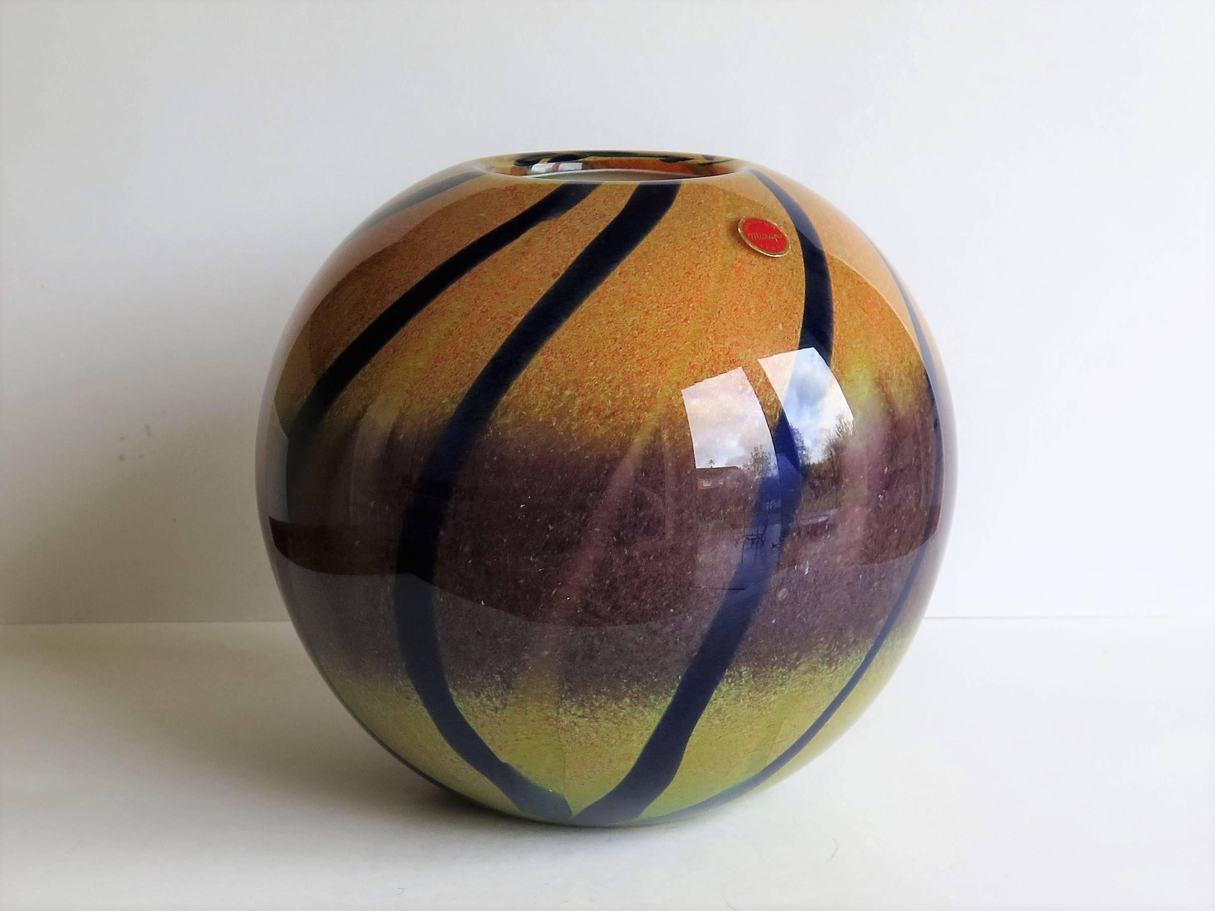 This is a beautiful Murano vase with a stunning mix of colors, having yellow with orange flecks to the top changing to a mauve / lilac in the middle section and yellow turning to light green at the base all in slightly varying shades. It then has