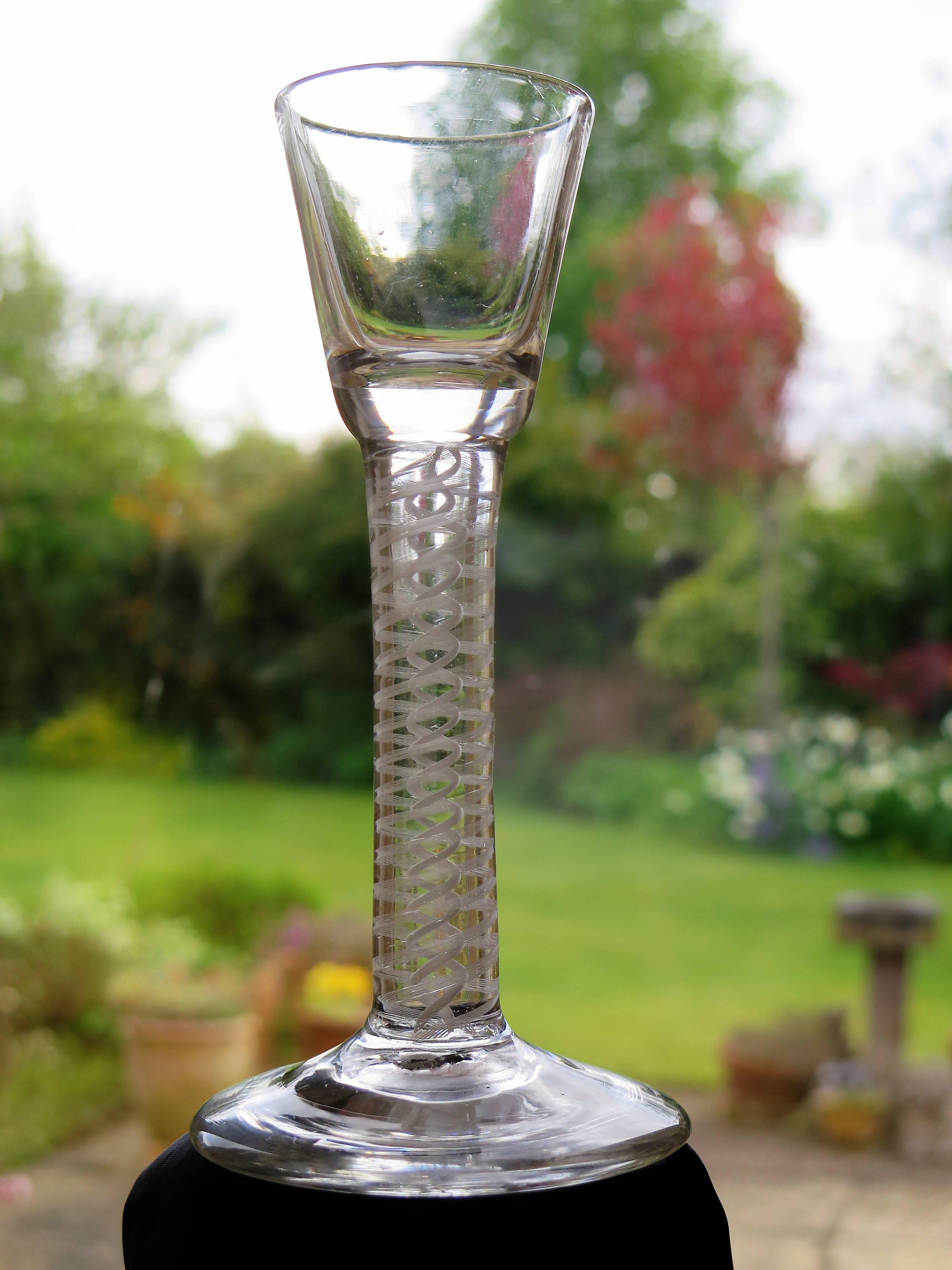 This is a superb hand-blown example of an Irish made, mid-Georgian, wine drinking glass with a thick double series opaque twist (DSOT) stem, dating from the middle of the 18th century, circa 1765 to 1770.

These glasses are very collectable. It is
