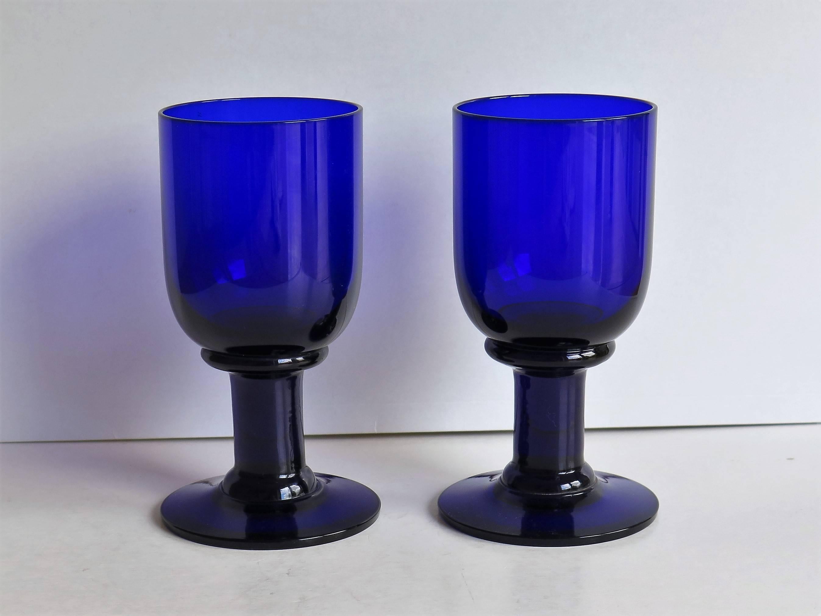 This is a good pair of English wine drinking glass goblets or Rummers from the late-19th century.

The glass is a deep Bristol Blue color. Colored glass was fashionable from the end of the 18th century and popular through the 19th century, the blue
