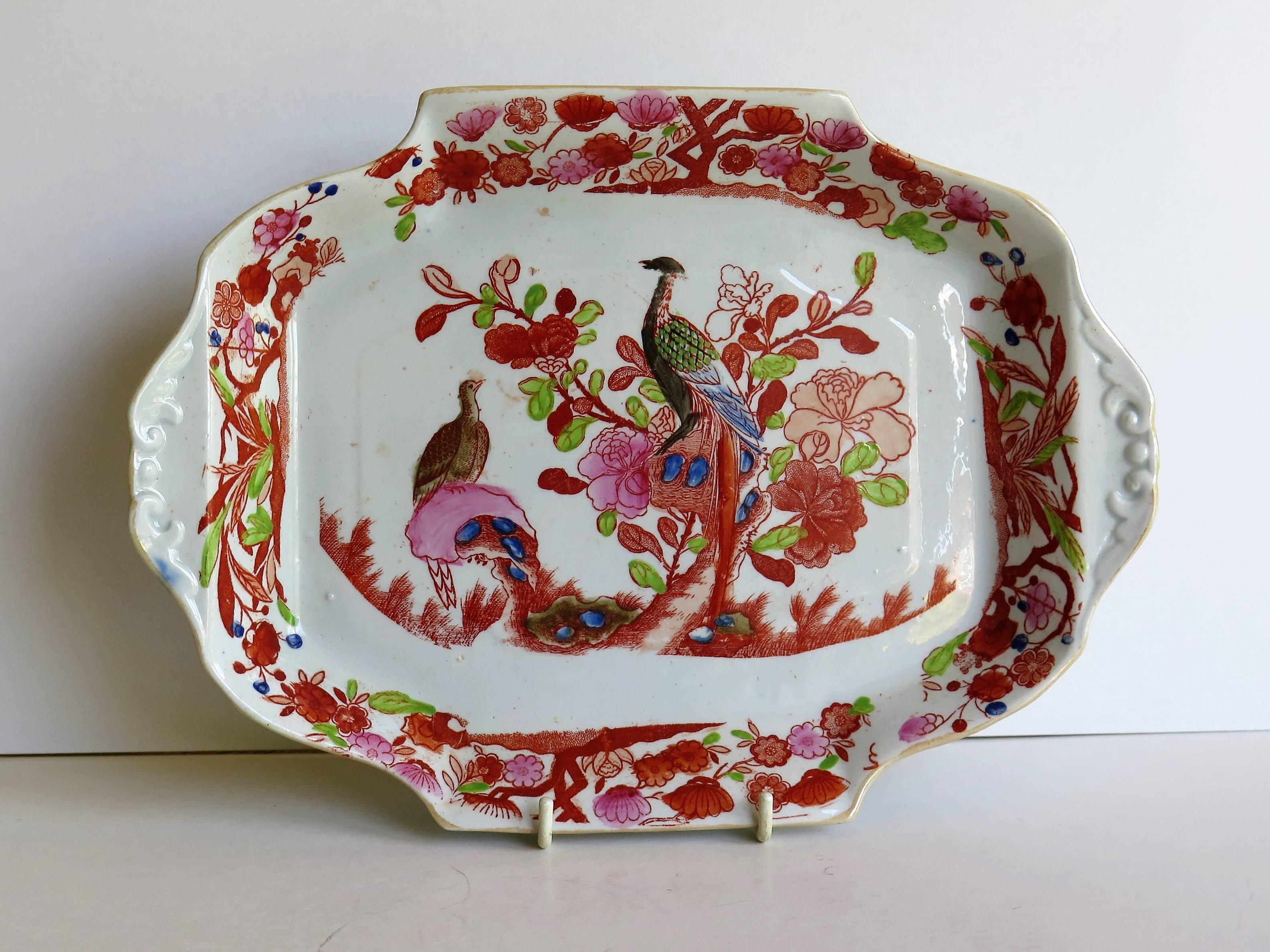 This is a very early Mason's ironstone serving dish, circa 1815.

This piece has two side handles with molded edging and would originally have been part of a desert service as illustrated on page 156 of Geoffrey Godden's book on Mason's China and