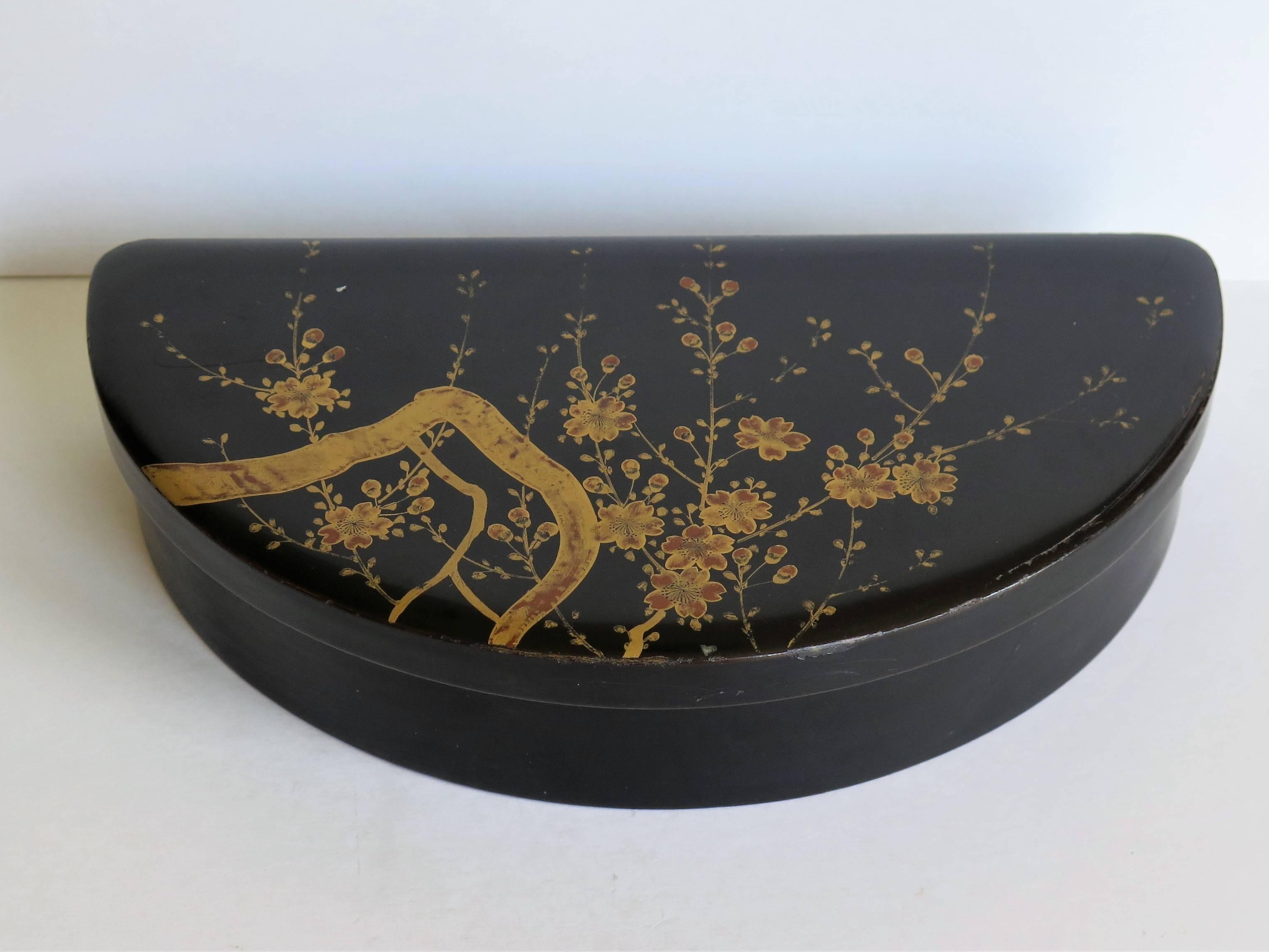 This is a beautiful papier mâché, lacquered box, which we attribute to being made in Japan during the early 20th century towards the end of the Meiji period, circa 1905. 

This is a very decorative lidded box with a semi circular shape and a very