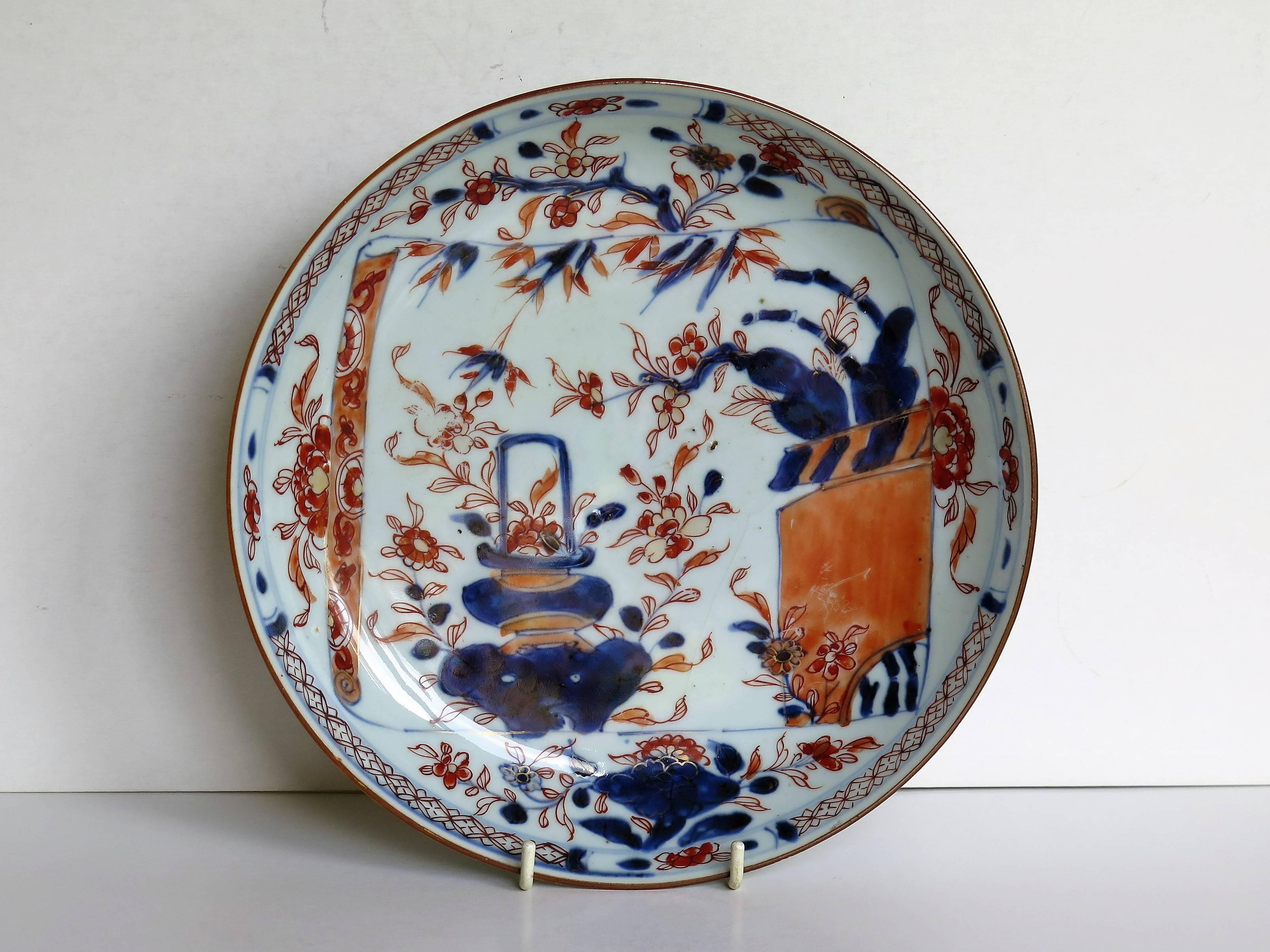 This is a fine hand-painted Chinese porcelain dish or plate with a deep well, dating to the very early 18th century, Qing Kangxi dynasty, circa 1710.

The glaze is thin and glassy with a soft light bluish tinge. The foot rim is fairly deep and