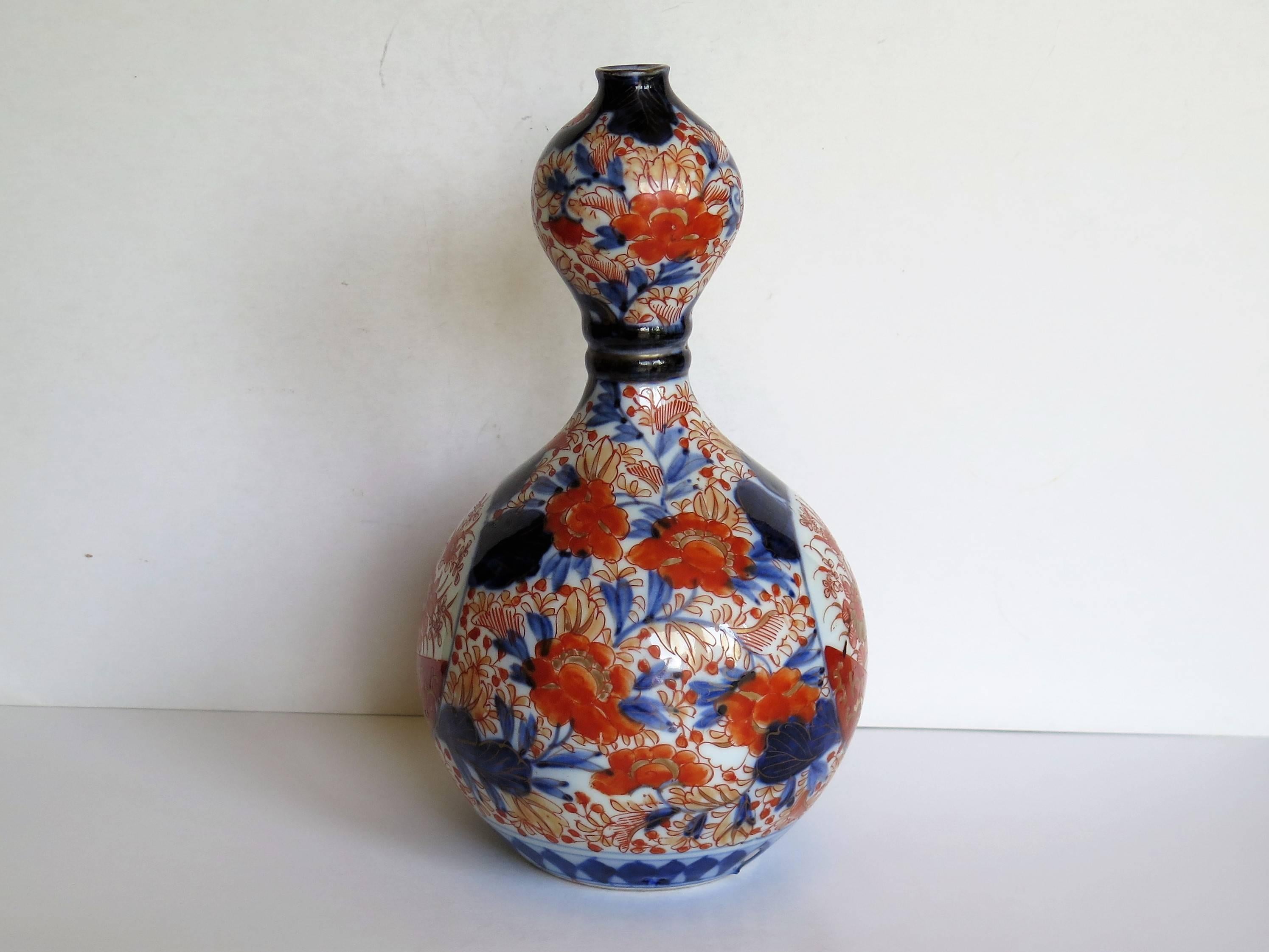 This is a very decorative Japanese Vase which we date to the ealy Meiji period of the 19th Century, circa 1870, but could be earlier in the 19th century.

This vase has a very distinctive and unusual Double Gourd, bulbous form, with a central ring