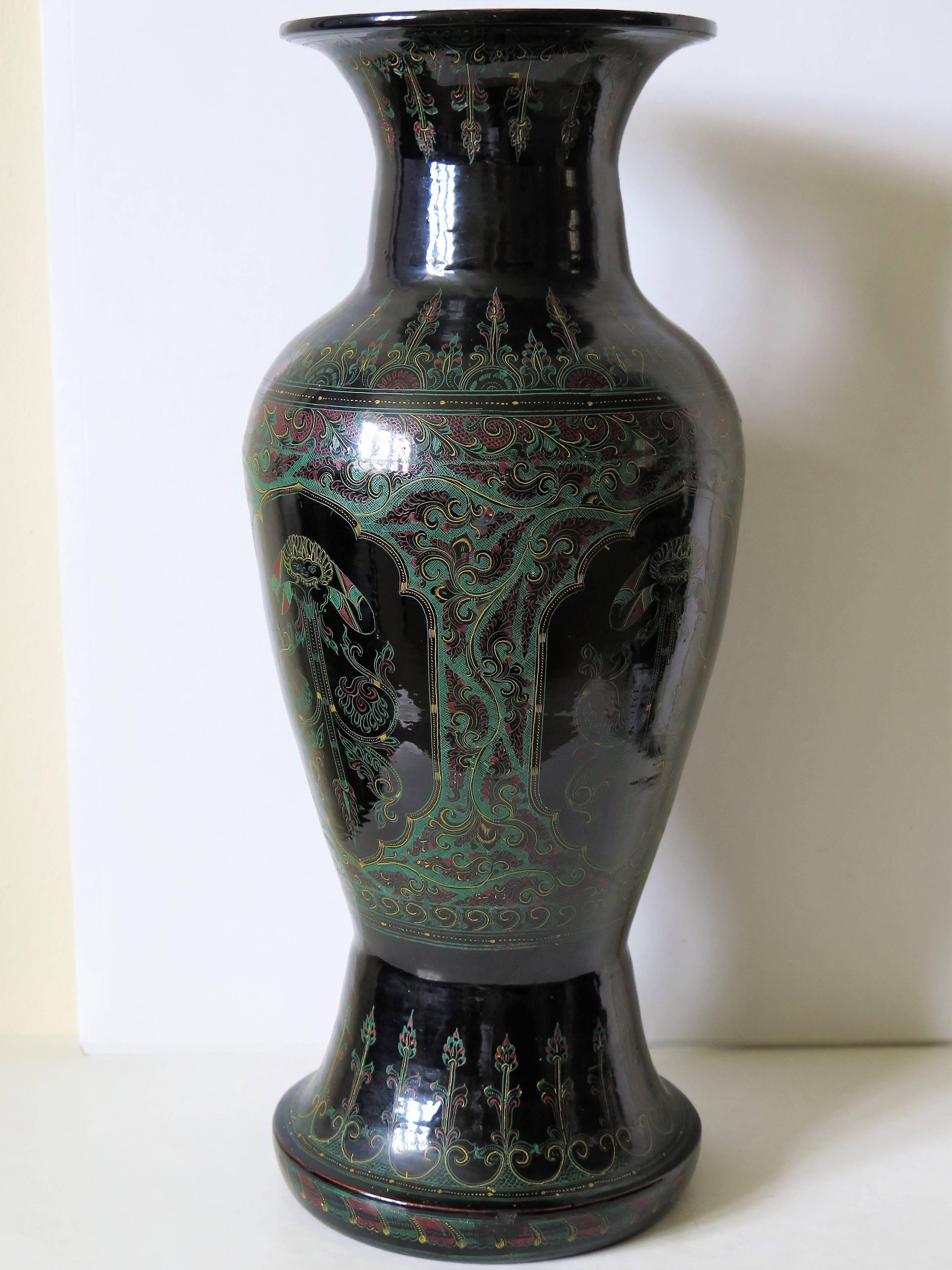 This is a large, unusual and very decorative Vase, made from Laquered Papier-Mache, which has been very finely hand painted and dating to the 19th century.

The vase has a baluster shape on a deep foot section and flared rim.

The vase has a black
