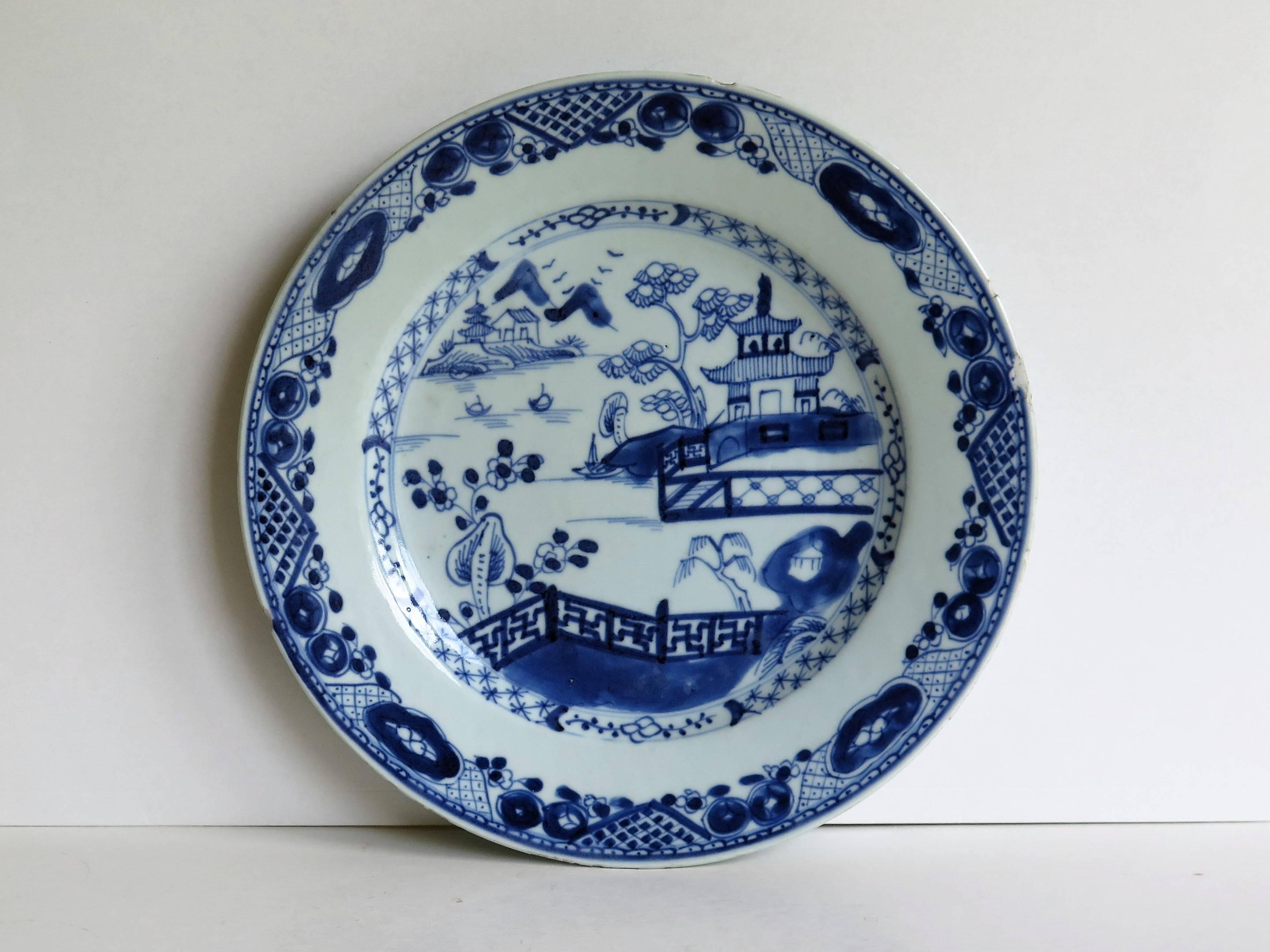 This is a Chinese porcelain plate made for the export (Canton) market, during the Qing dynasty in the second half of the 18th century, circa 1780.

The plate is hand decorated in varying shades of cobalt blue in a free flowing style, with a glaze