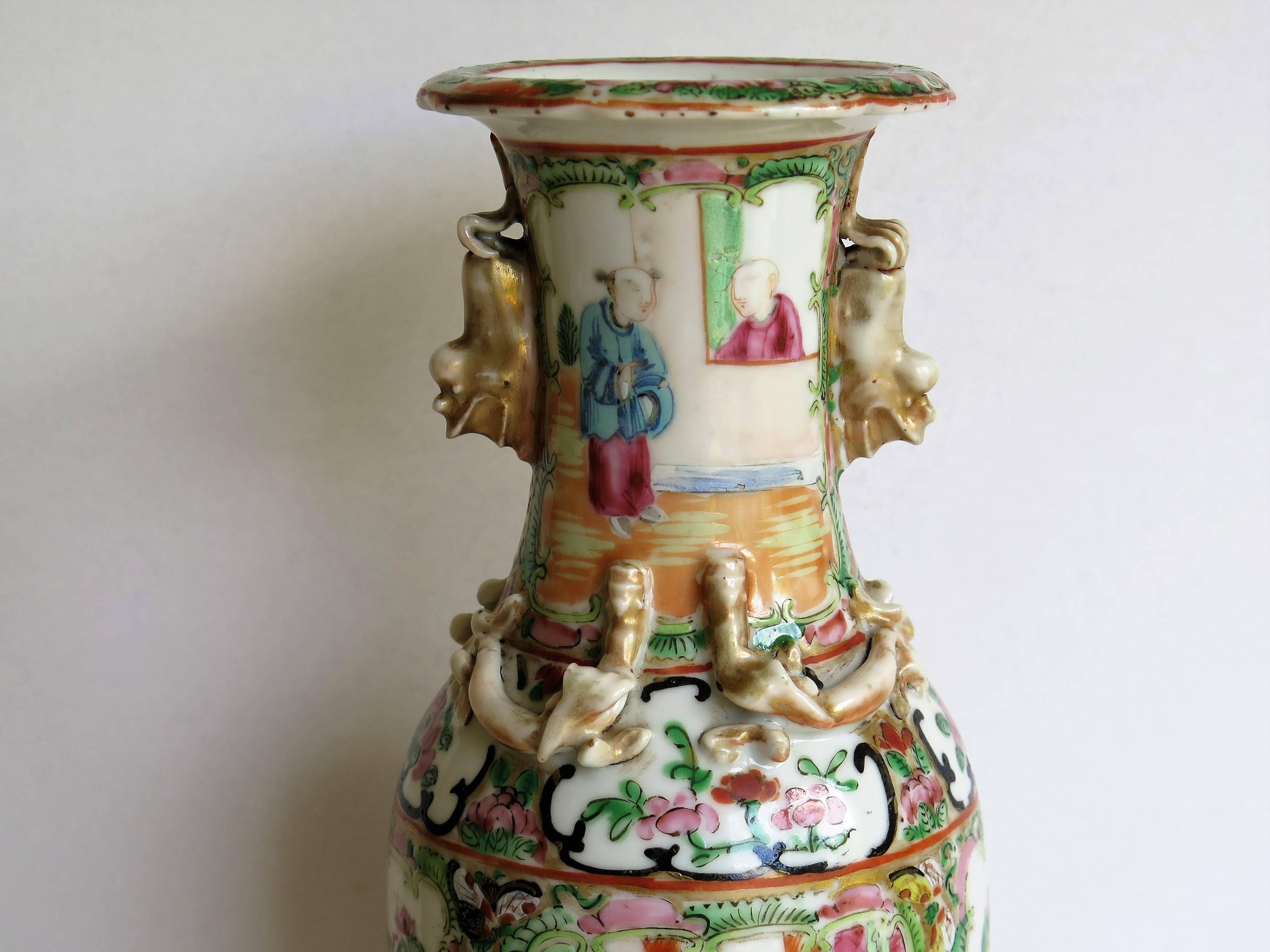 This is a very decorative Chinese export, porcelain, rose medallion Vase which we date to the 19th century, Qing dynasty, circa 1860.

The vase has a baluster shape with a flared rim and is embellished with two gilded Foo Dog handles and four