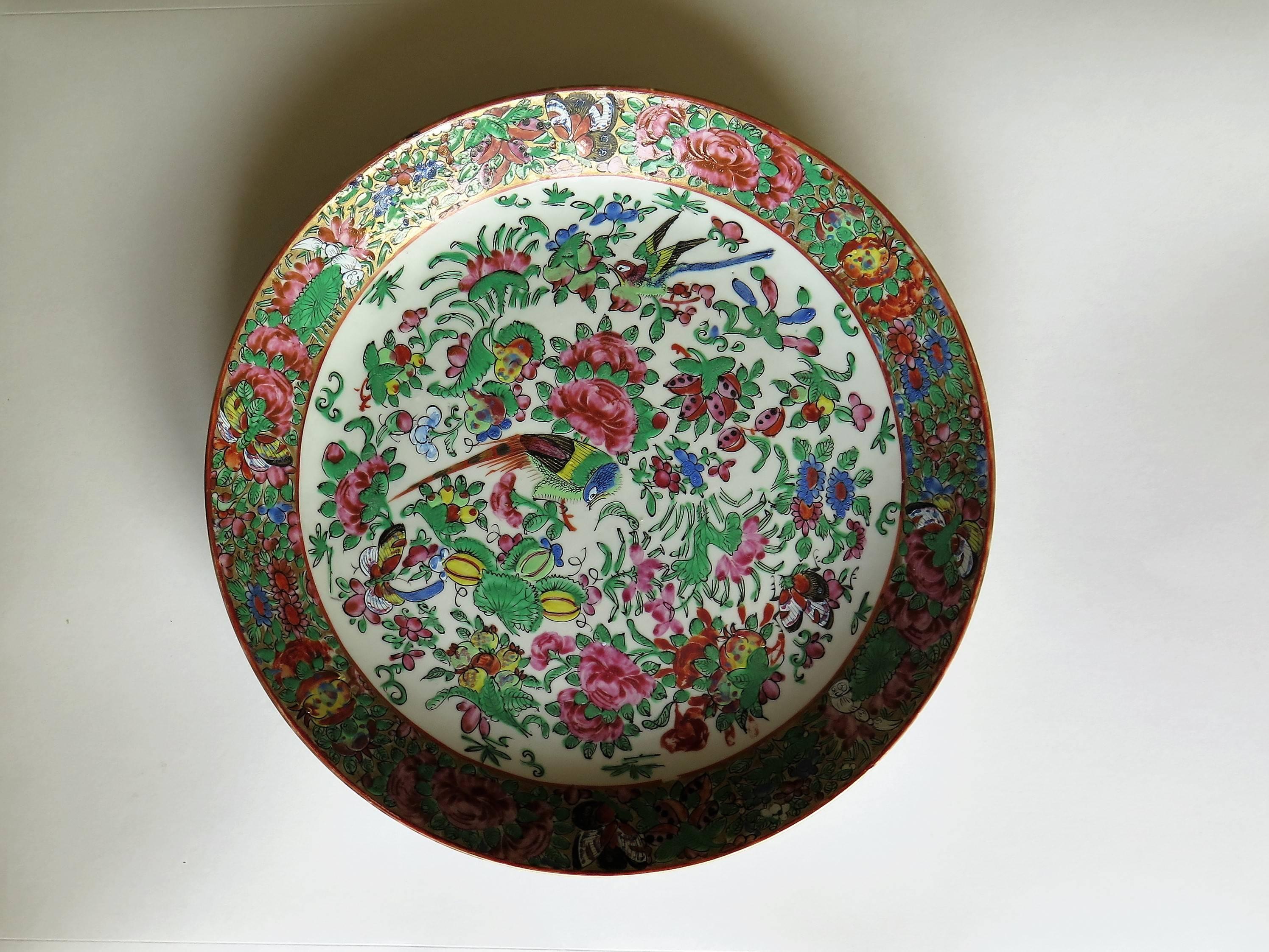 This is a Chinese porcelain, beautifully decorated large Dish or Deep Plate made for the Chinese Export (Canton) market, which we date to the 19th Century, circa 1880.

It is hand-painted in the Famille Rose palette of enamels. The central well has