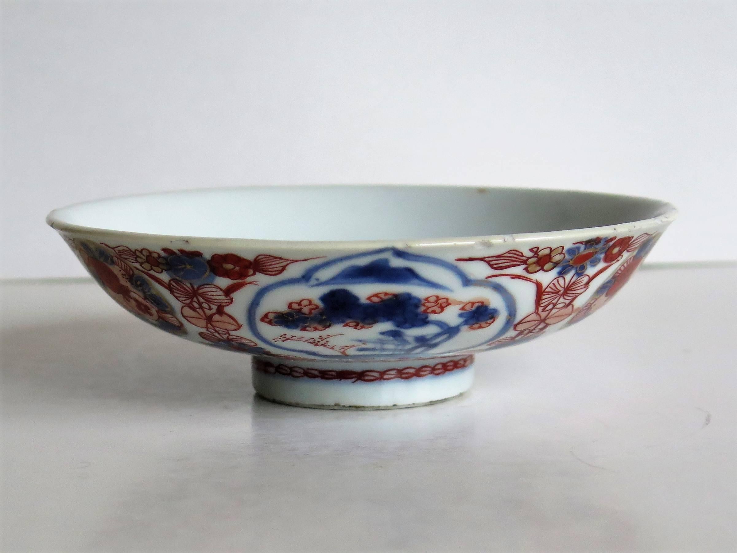 This is a beautiful Chinese porcelain footed bowl that we date to the Qing, Kangxi period, circa 1700.

This bowl is fairly shallow with an everted rim and sits on a tall foot, very similar to the tall feet on bowls of the earlier Ming Period. The