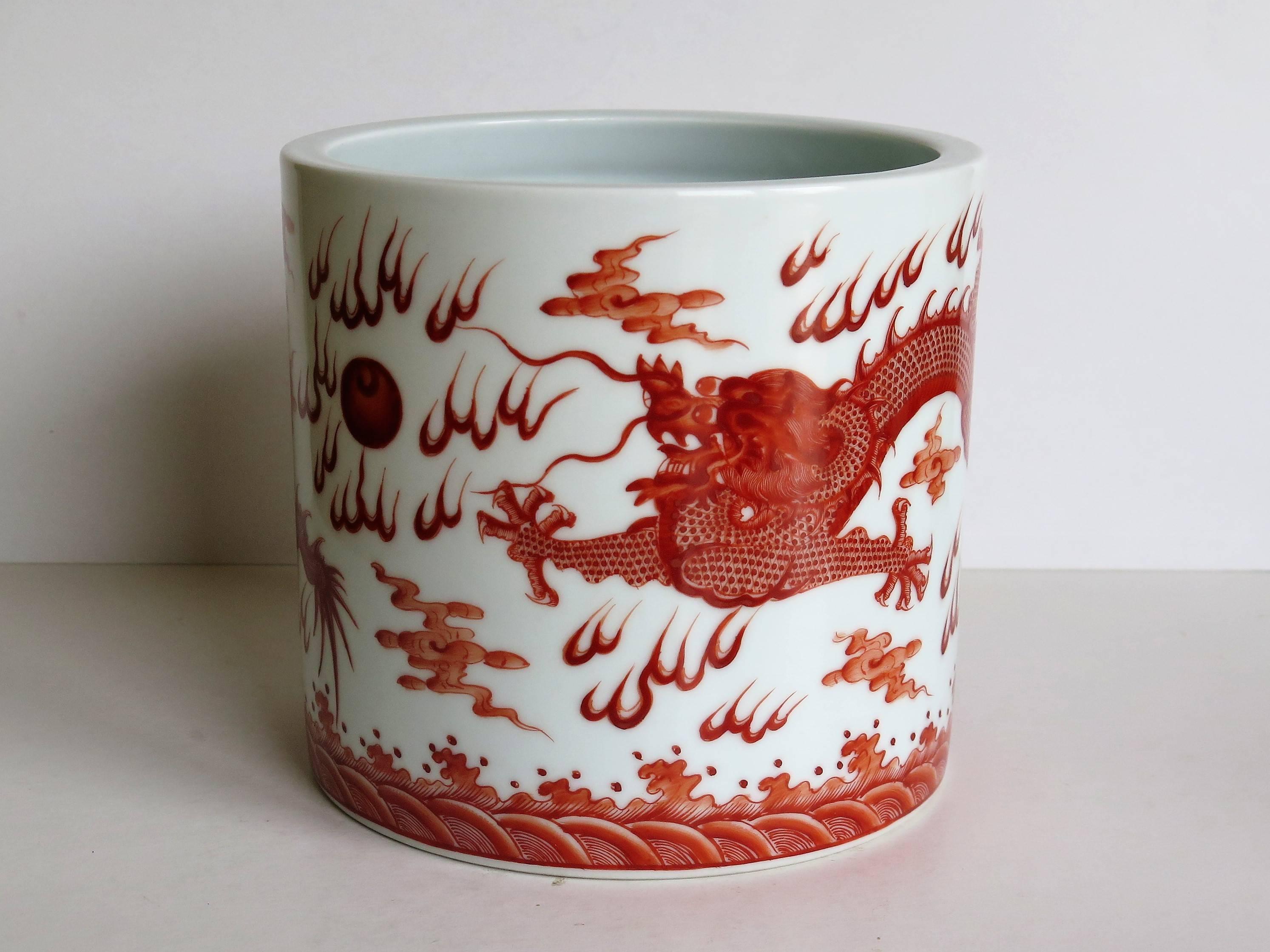 This is a high quality Chinese porcelain brush pot which are often used as jardinieres

The pot is nominally straight sided with a recessed circular indentation to the unglazed base.
The piece is finely potted with a very white glaze. 

It is