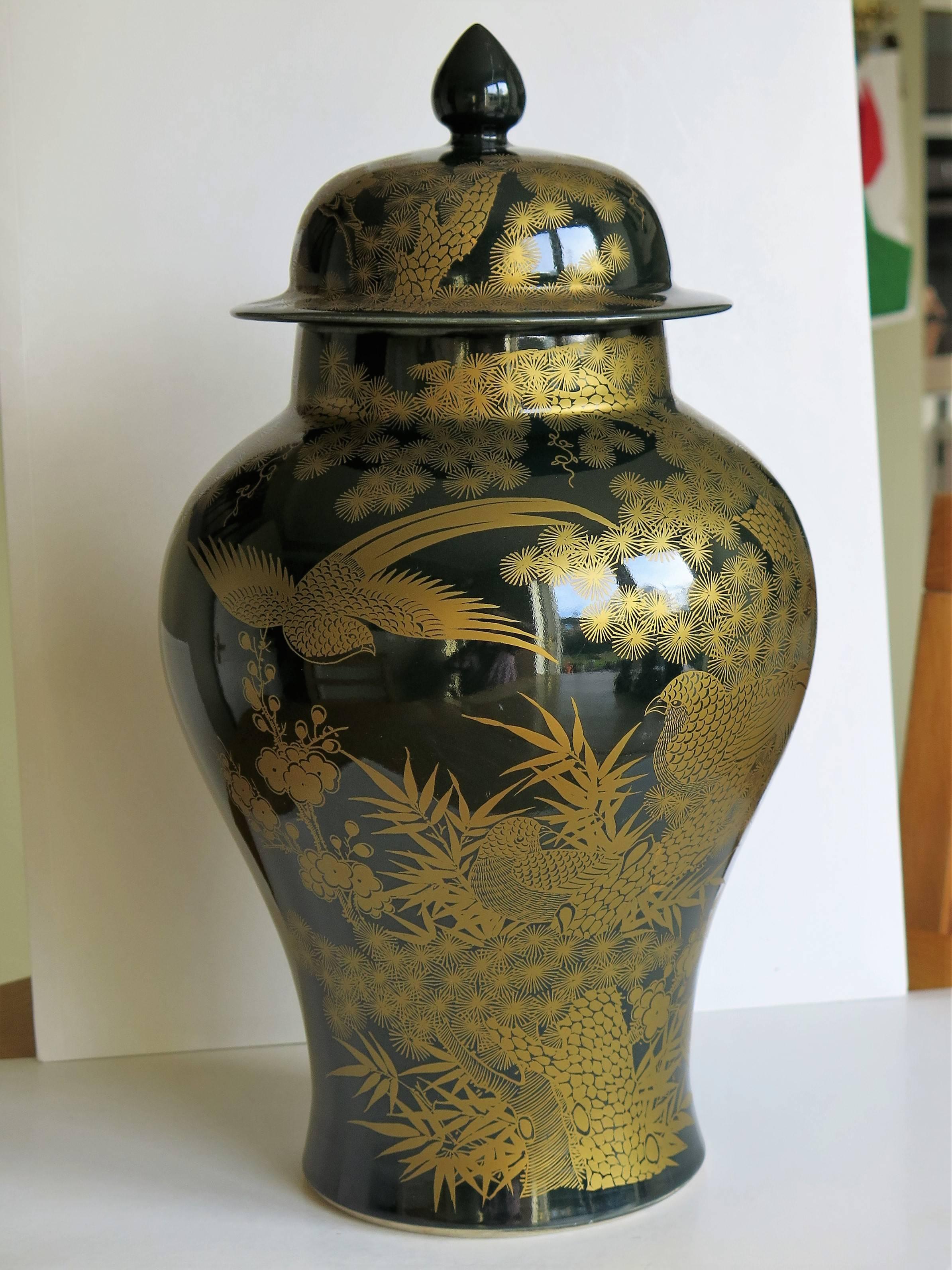 This is a beautiful Chinese porcelain lidded Vase or Jar which we date to the late 19th century, Qing period.

The vase has a monochrome (single color) glaze in a deep dark green. It has then been finely hand decorated in gilt (gold) with birds set