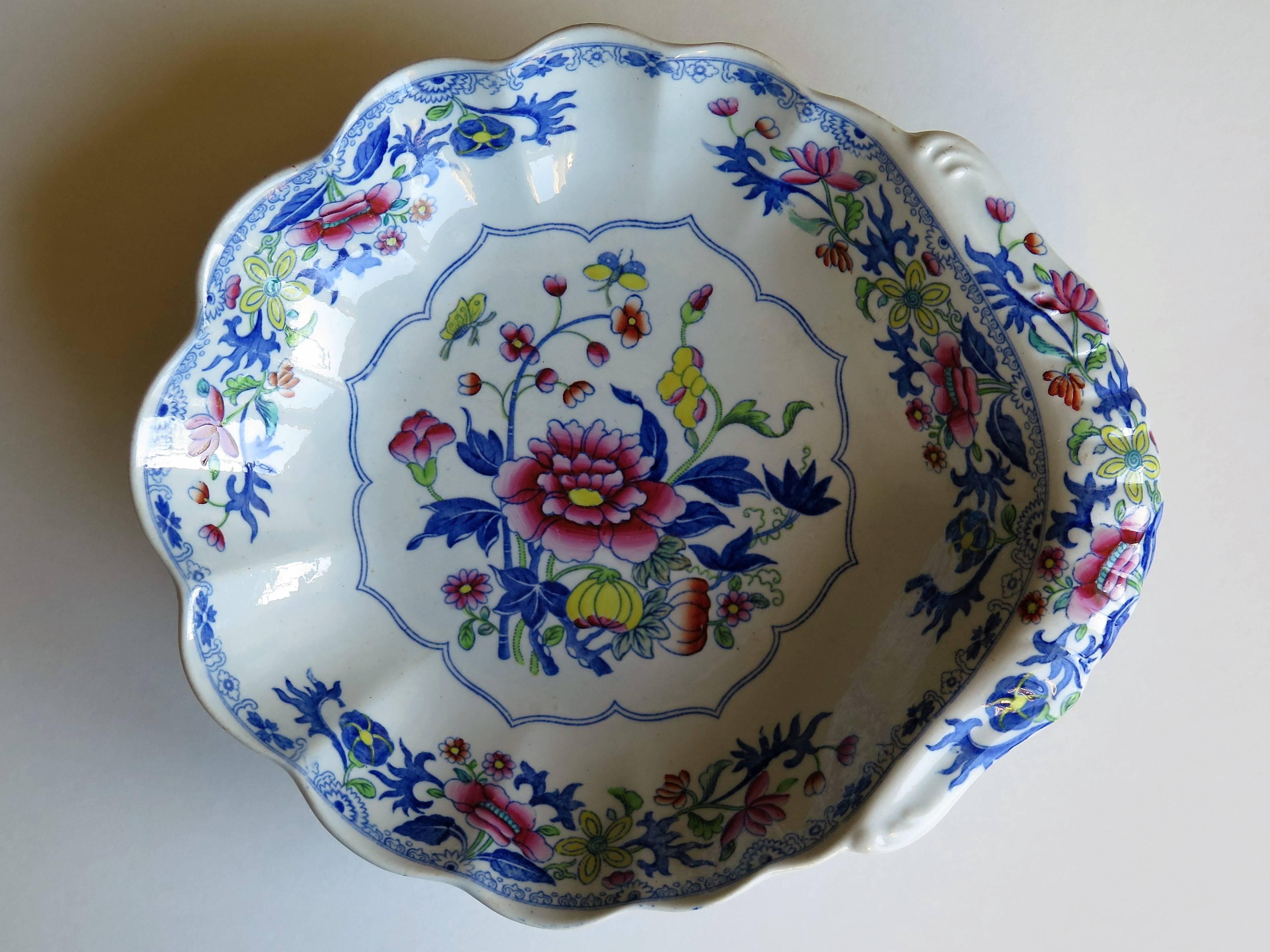 This is an early 19th century stone china (Ironstone pottery) desert dish with a fluted shell shape, produced by Spode and dating from the George 111rd period, circa 1820.

It is decorated in one of Spode's chinoiserie influenced floral patterns