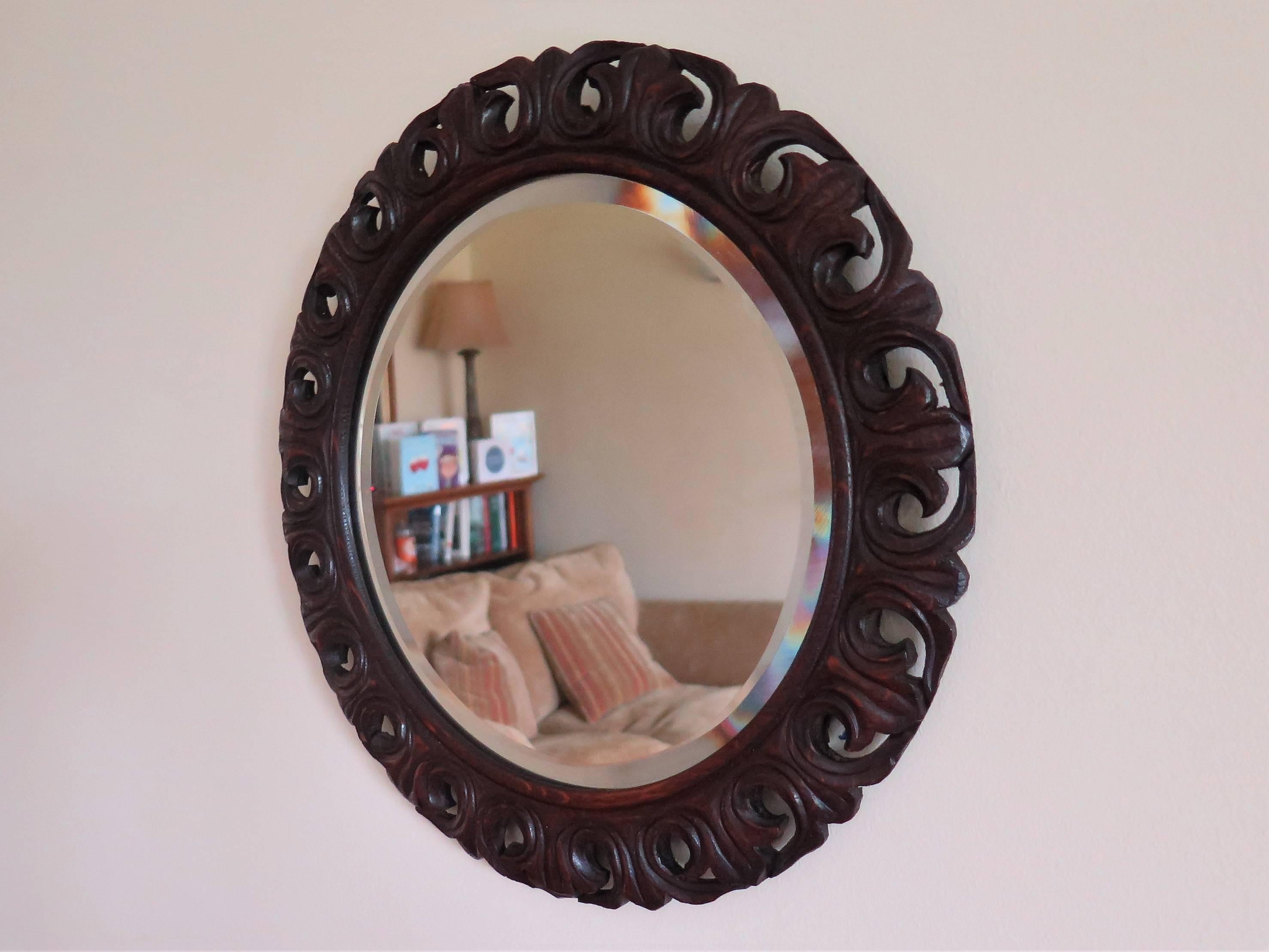 This is a good and unusual oak framed circular mirror which we date to the late 19th century.

The frame is made of solid oak and has been beautifully hand carved in a continuous pierced scroll form in a Jackobean style, typically seen on early