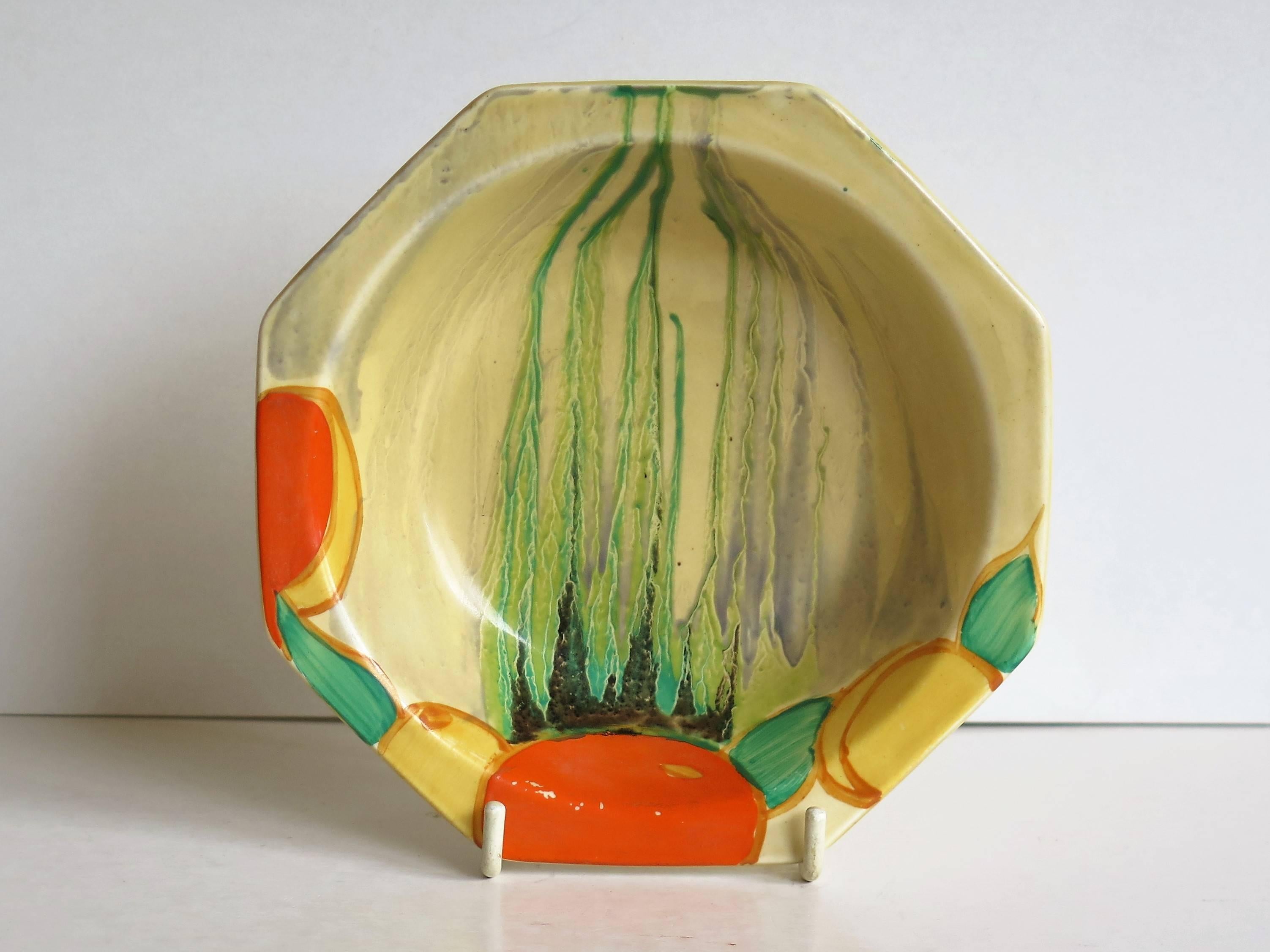 This is a small octagonal bowl by Clarice Cliff in the Delecia pattern, circa 1932.

The Delecia pattern was first introduced in 1930 and ran with various versions until 1934. We think this bowl is painted in the Delecia Citrus pattern, introduced