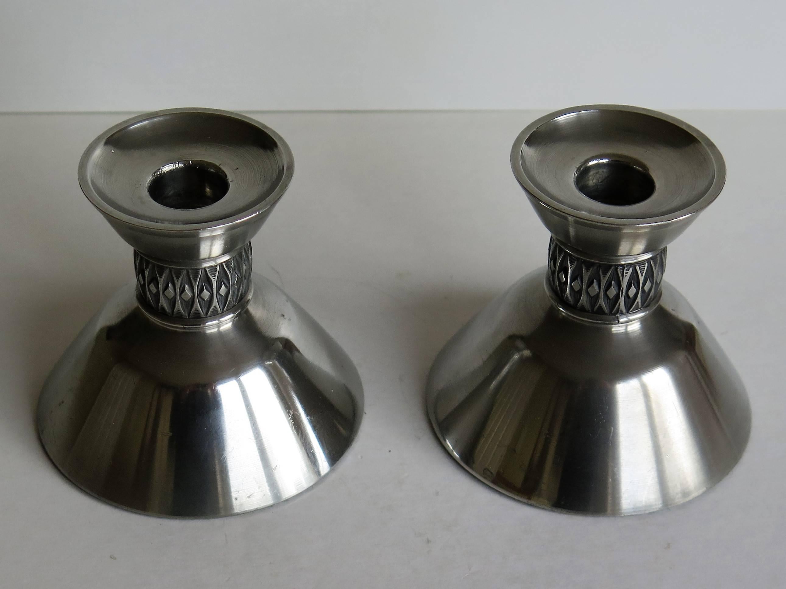 These are a good PAIR of Mid-Century Pewter Candle holders made by Mastad Pewter, Norway and signed 101 which is the model or design number.

The candleholders are probably cast, then polished and have a continuous raised diamond in an ellipse motif