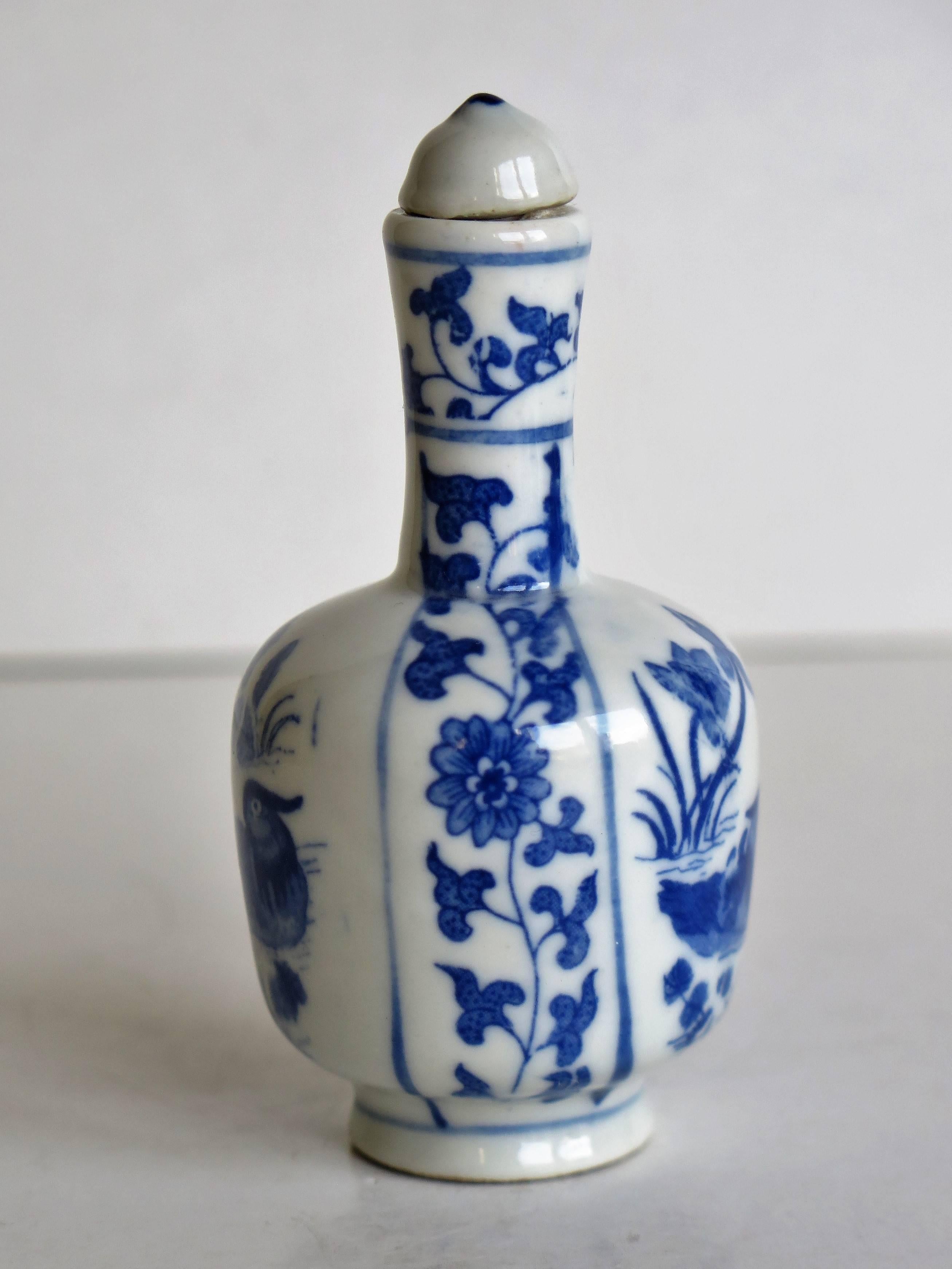 This is a good quality Chinese snuff bottle, made from porcelain, circa 1930.

The cylindrical snuff bottle is bottle shaped on a low foot and narrow neck. The main decoration depicts a well painted design with a pair of mandarin ducks in a