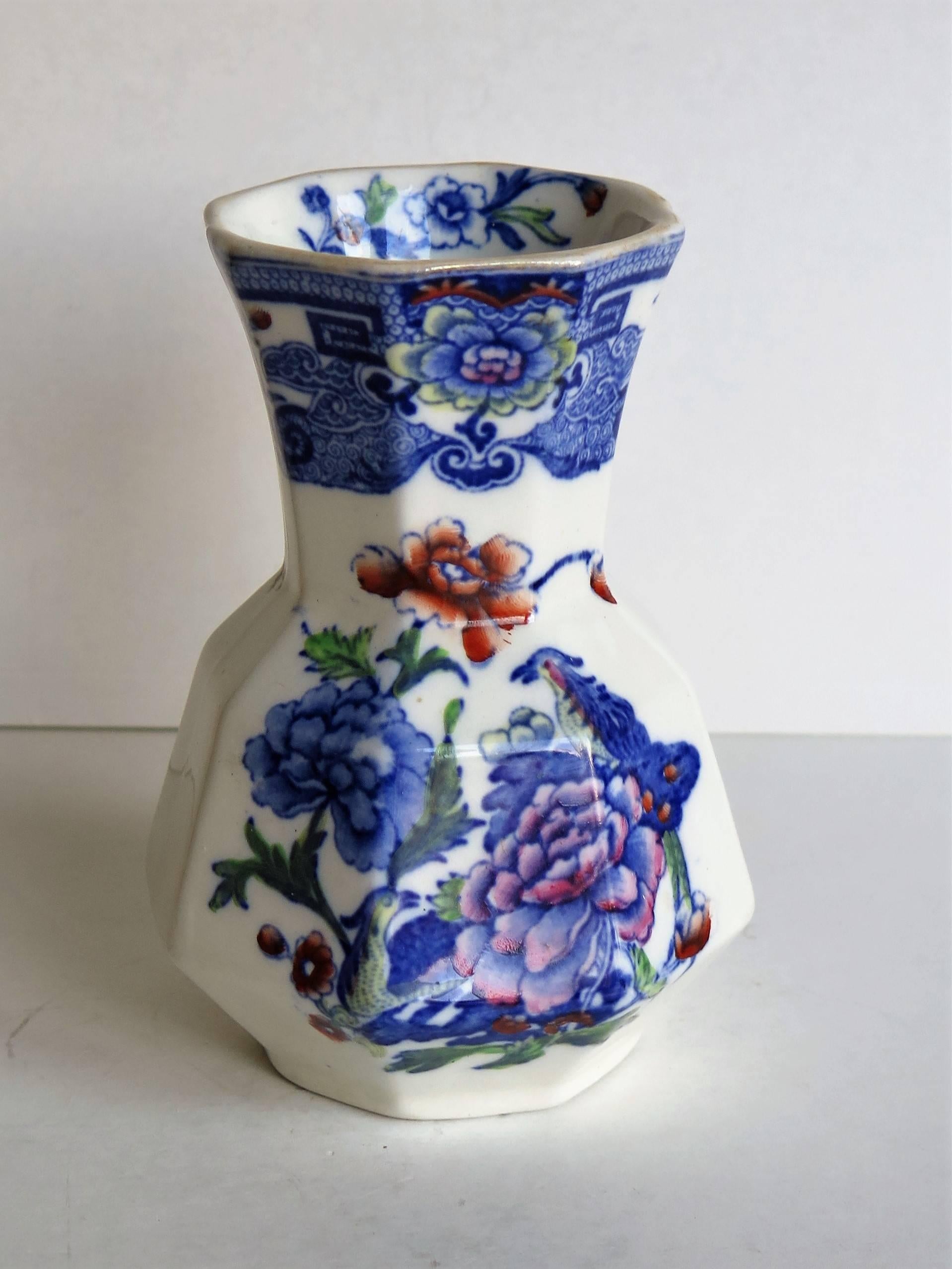 This is a good spill vase or beaker made by Mason's ironstone, Lane Delph, England in the last quarter of the 19th century, circa 1880.

The pattern is called India Pheasant and shows two birds perched by two large peonies in a blue and white