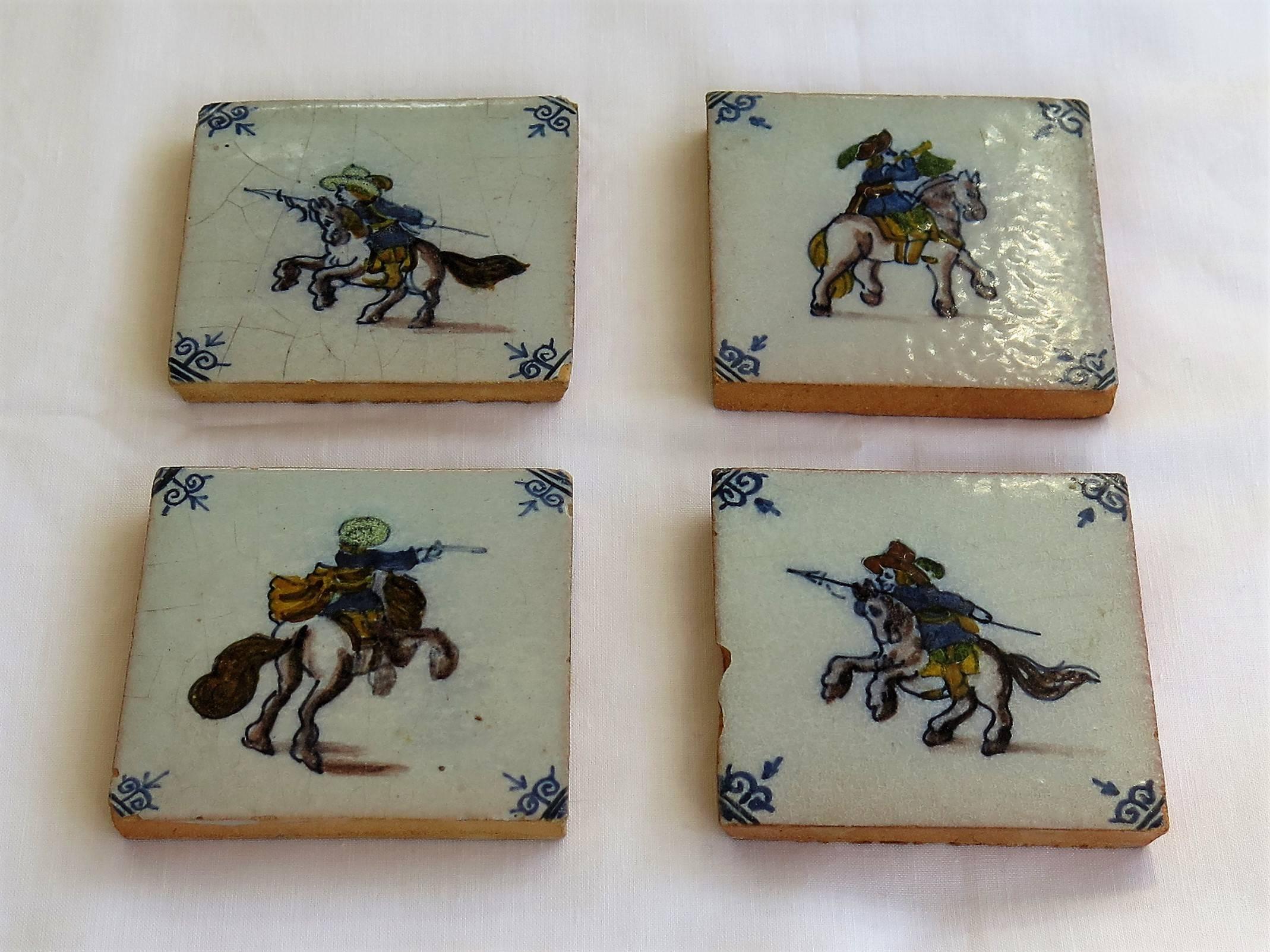 These are a very decorative set of 4 small ceramic wall tiles, with a military horse riding theme, dating to the later part of the 18th century or early in the 19th Century.

All four tiles are nominally 3 inches square and 3/8 inch thick.

The