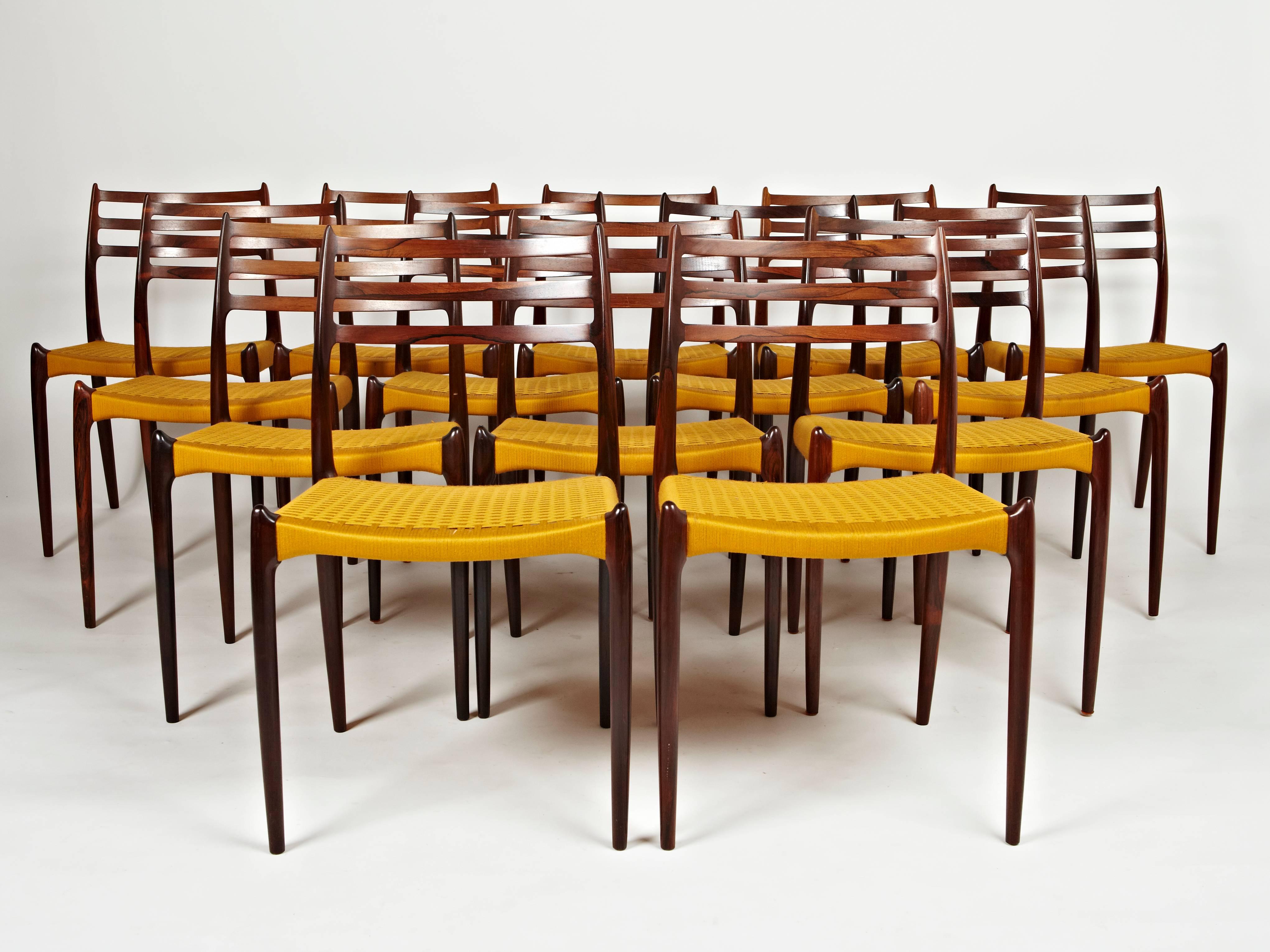 This group of 16 rosewood dining chairs (14 chairs pictured) designed by Niels Otto Møller in 1962 and made and labelled by JL Moller before 1969 is truly unique. Each frame is made of rosewood with an amazing play of colors and black veining.