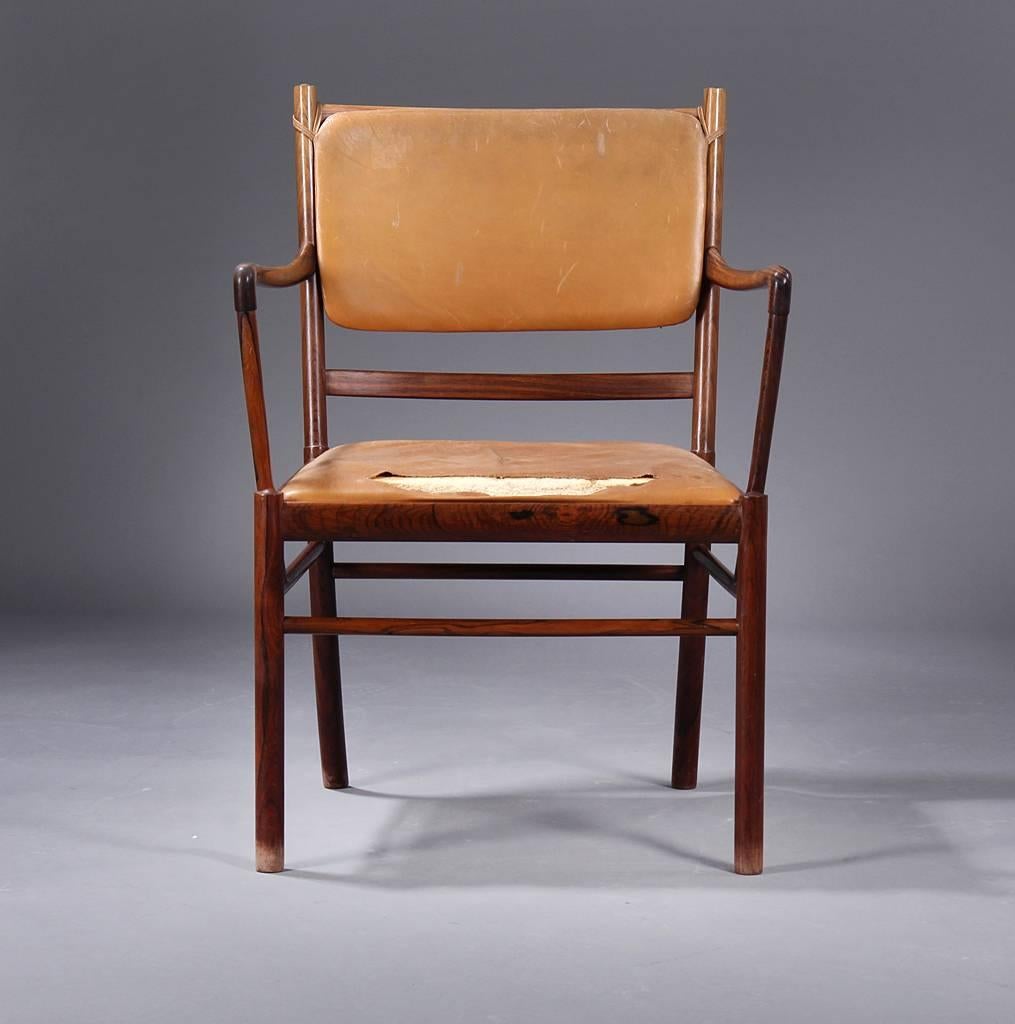 This very fine example of Ole Wanscher's Colonial chair in a desk chair edition is made up of the fanciest, high contrast rosewood. Not all chairs are created equal in that the wood selection can make the chair truly rare or run of the mill. This