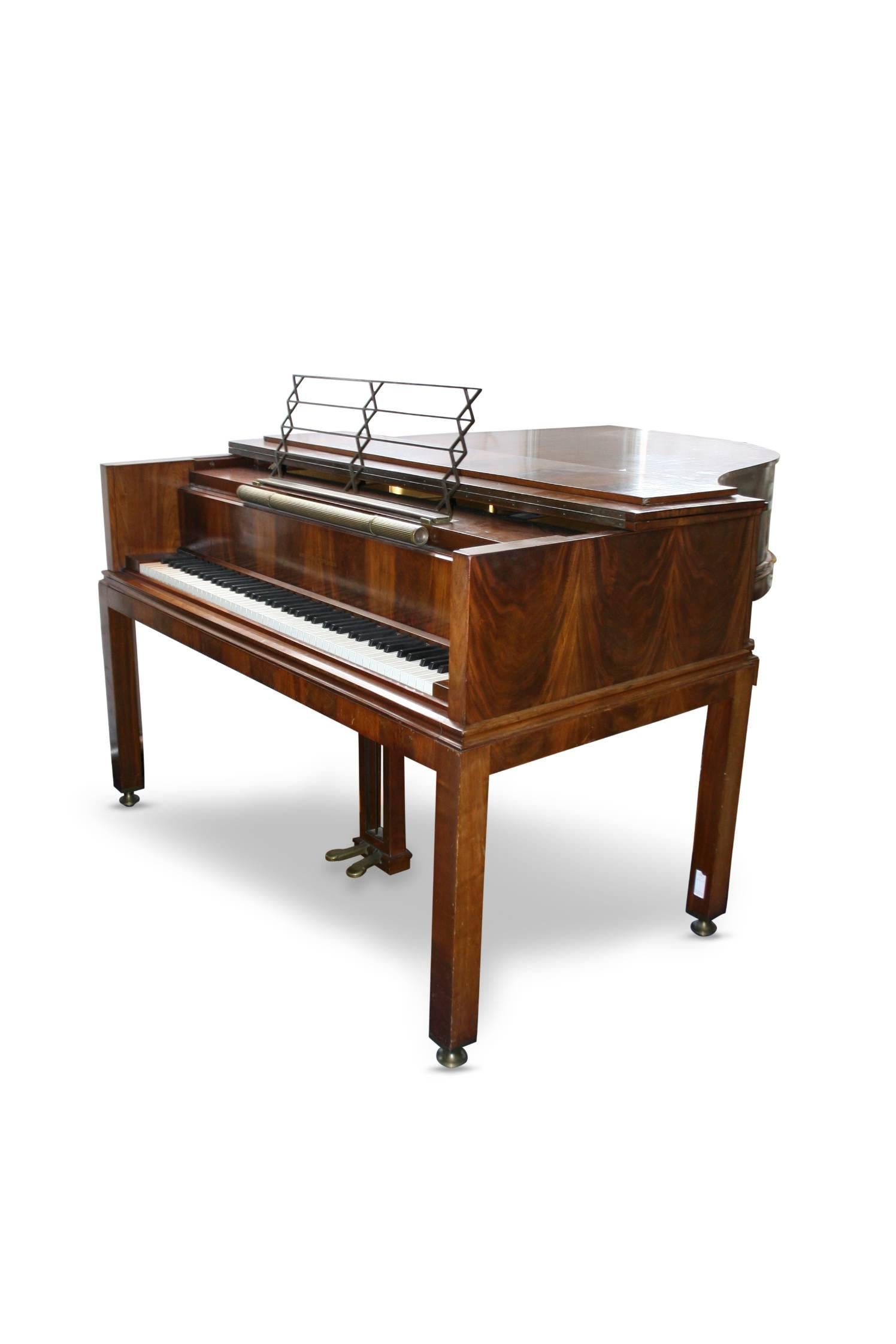 Unique grand piano of mahogany designed by renowned architect Bent Helweg-Moller and made by Denmark's leading piano maker in 1929. On four legged frame with brass shoes. Seven octaves, mounted with sheet holder and brass lamp with up-light, light