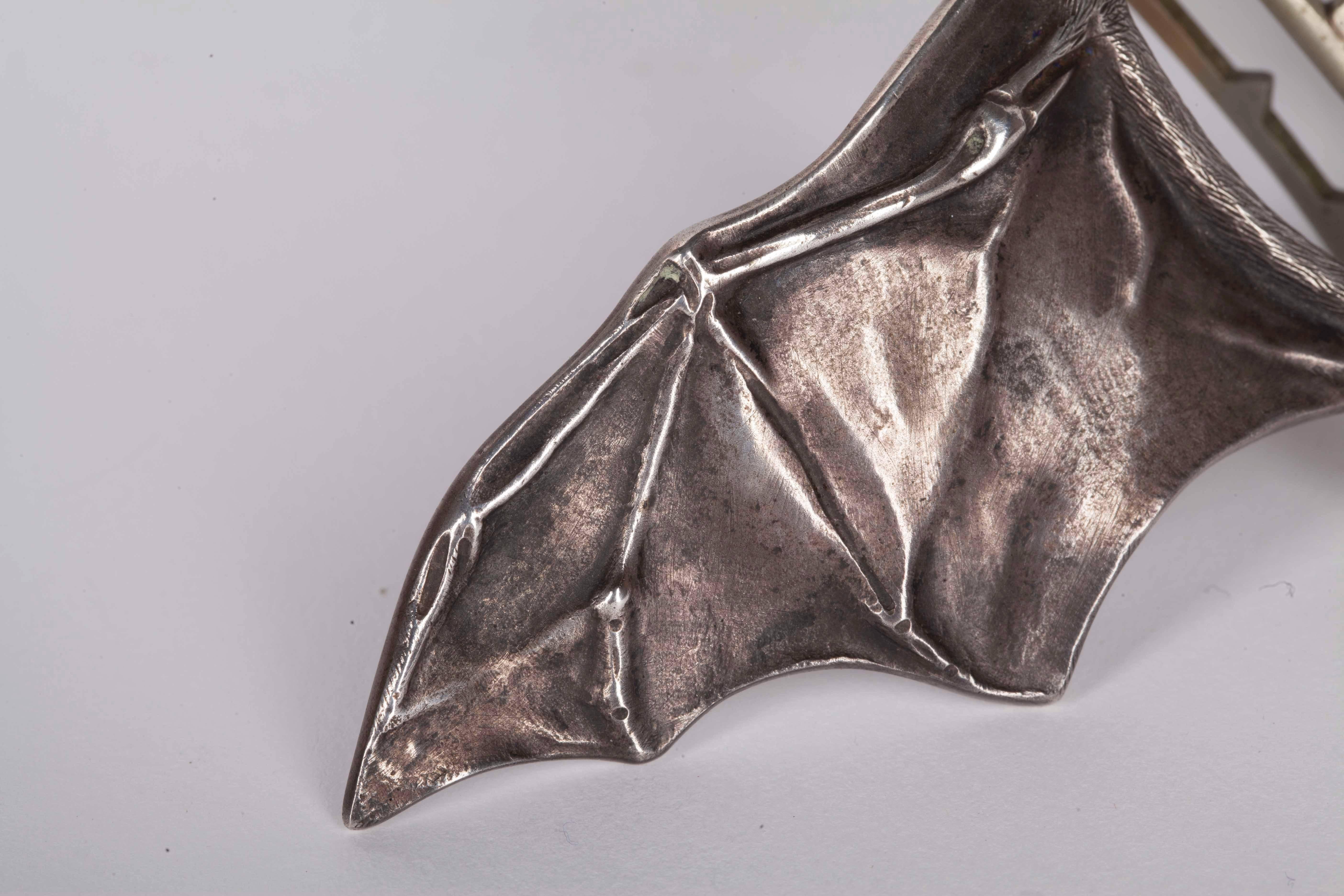 Beautiful worked silver buckle in the form of a bat by Ferdinand Erhart, circa 1908. Similar buckles are in the collection of The Rijksmuseum Amsterdam since 1984 and in Musée d'Orsay, Paris since 1997.

It has been marked: 'FE' with a flower in a