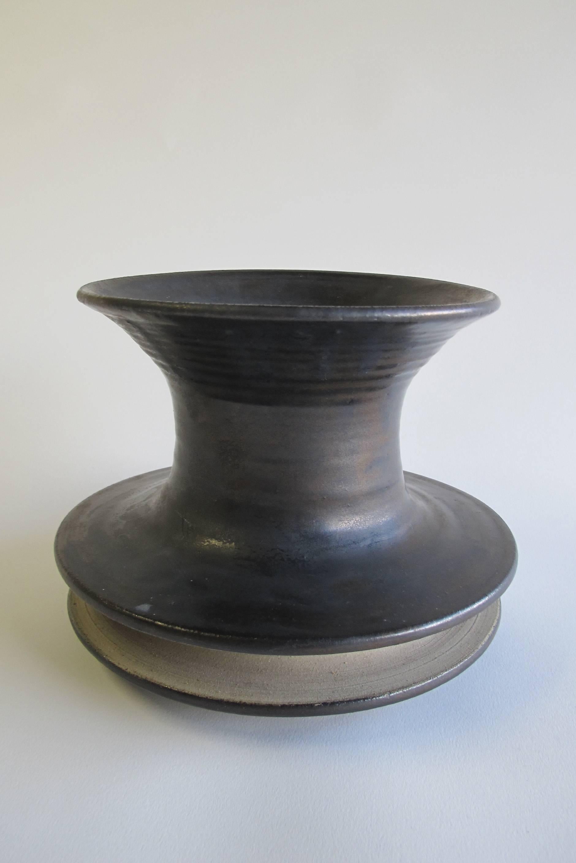 Bronze glazed stoneware vase made by Jan van der Vaart in 1966 in his own studio. This piece of Dutch Avant Garde pottery with geometric shape and a double collar was executed in 1966 in his own studio. De vase is marked at the bottom with a wheel