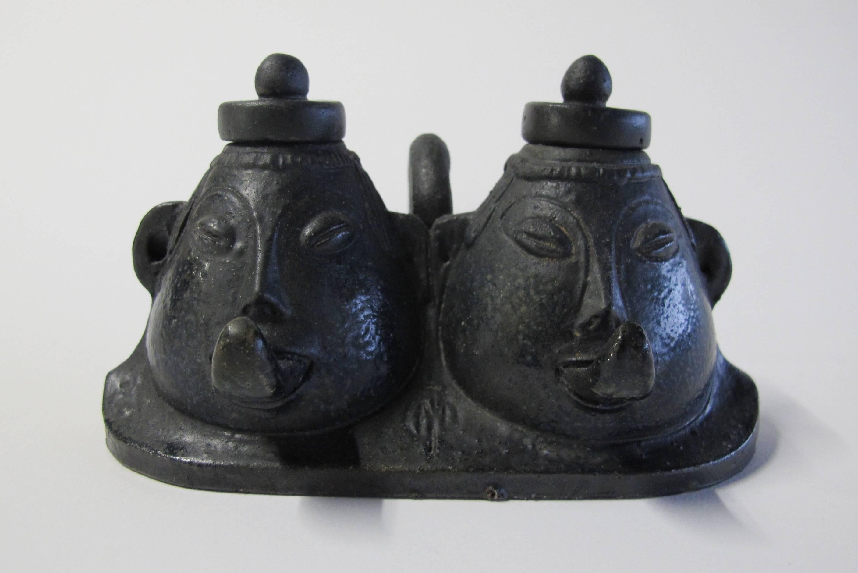 Beautiful inkstand with two inkpots designed by Dutch Art Nouveau artist Joseph Mendes Da Costa. The inkstand is made out of black grès cérame, circa 1900. The inkstand has two pear-shaped grotesque heads out that can be filled with ink. Both heads
