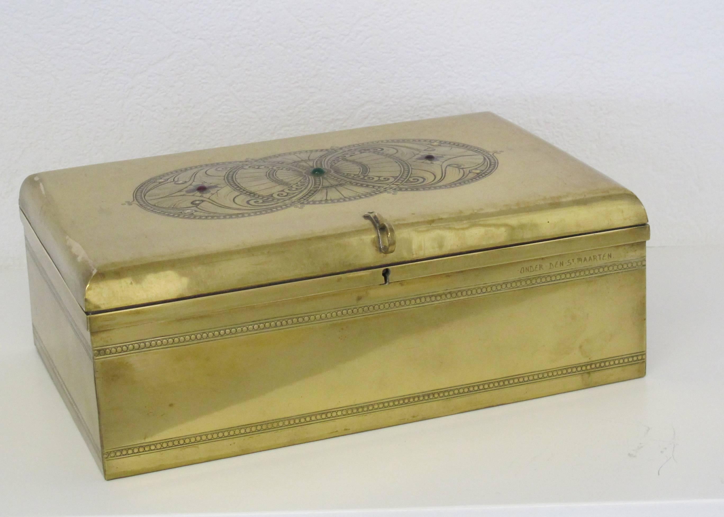 This solid brass chest was designed bij J.C. Stoffels and produced at the furniture factory Onder den Sint Maarten, circa 1905. The sides of the box are adorned by two rows of circles encapsulated between double lines. The top of the box is