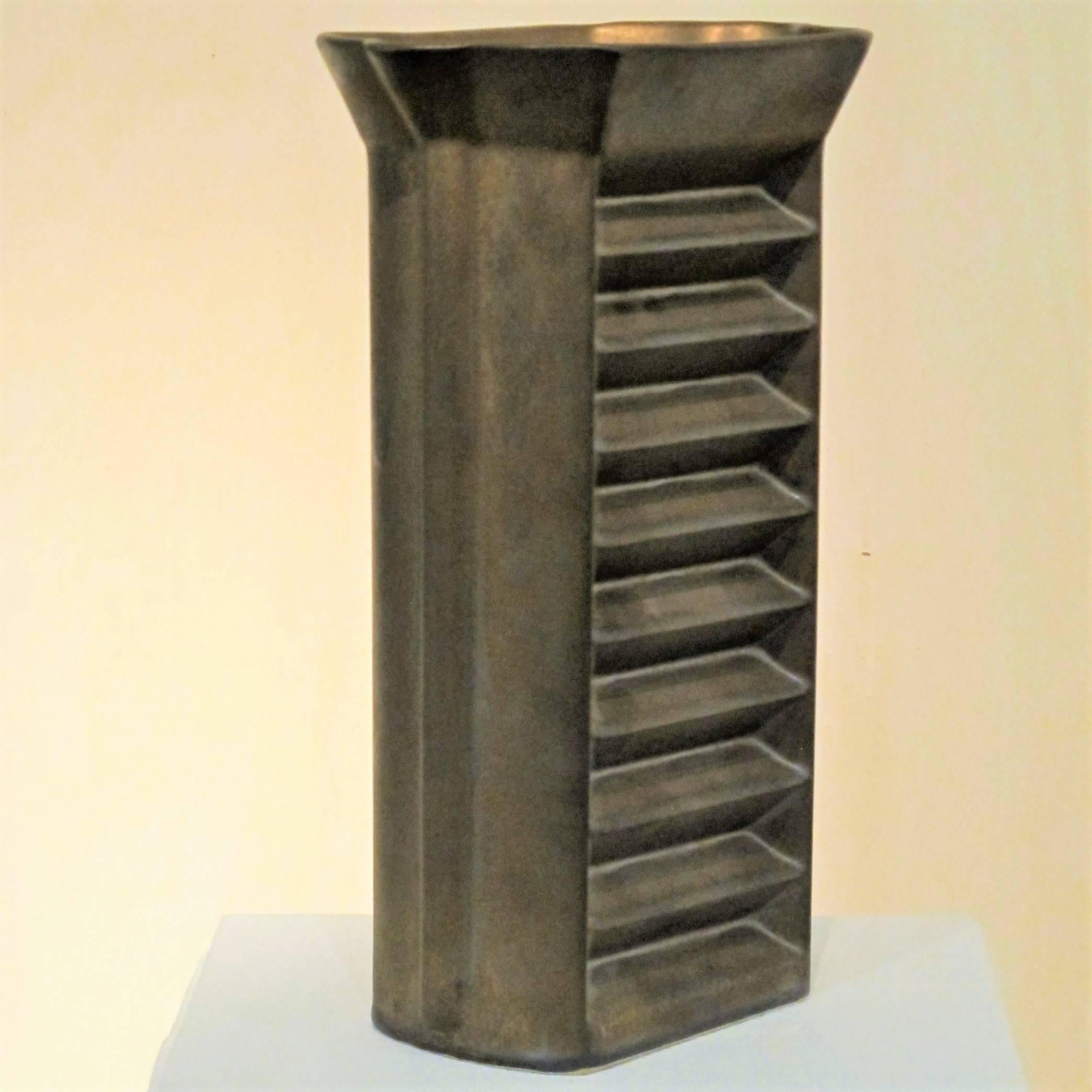 Bronze glazed stoneware vase by Jan van der Vaart. This piece of Dutch Avant Garde pottery with geometric shape en ridges was executed in 1997 in his own workshop. De vase is markes at the botttom: 'VD VAART 97'.

Jan van der Vaart (1931-2000) was