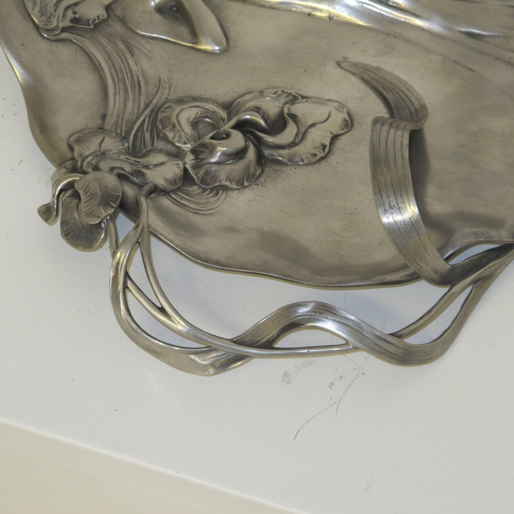 Beautiful Italian Art Nouveau pewter dish with female figure and iris, its leaves  coming out of the plate.
Stamped with the marks of Achille Gamba, see picture.

