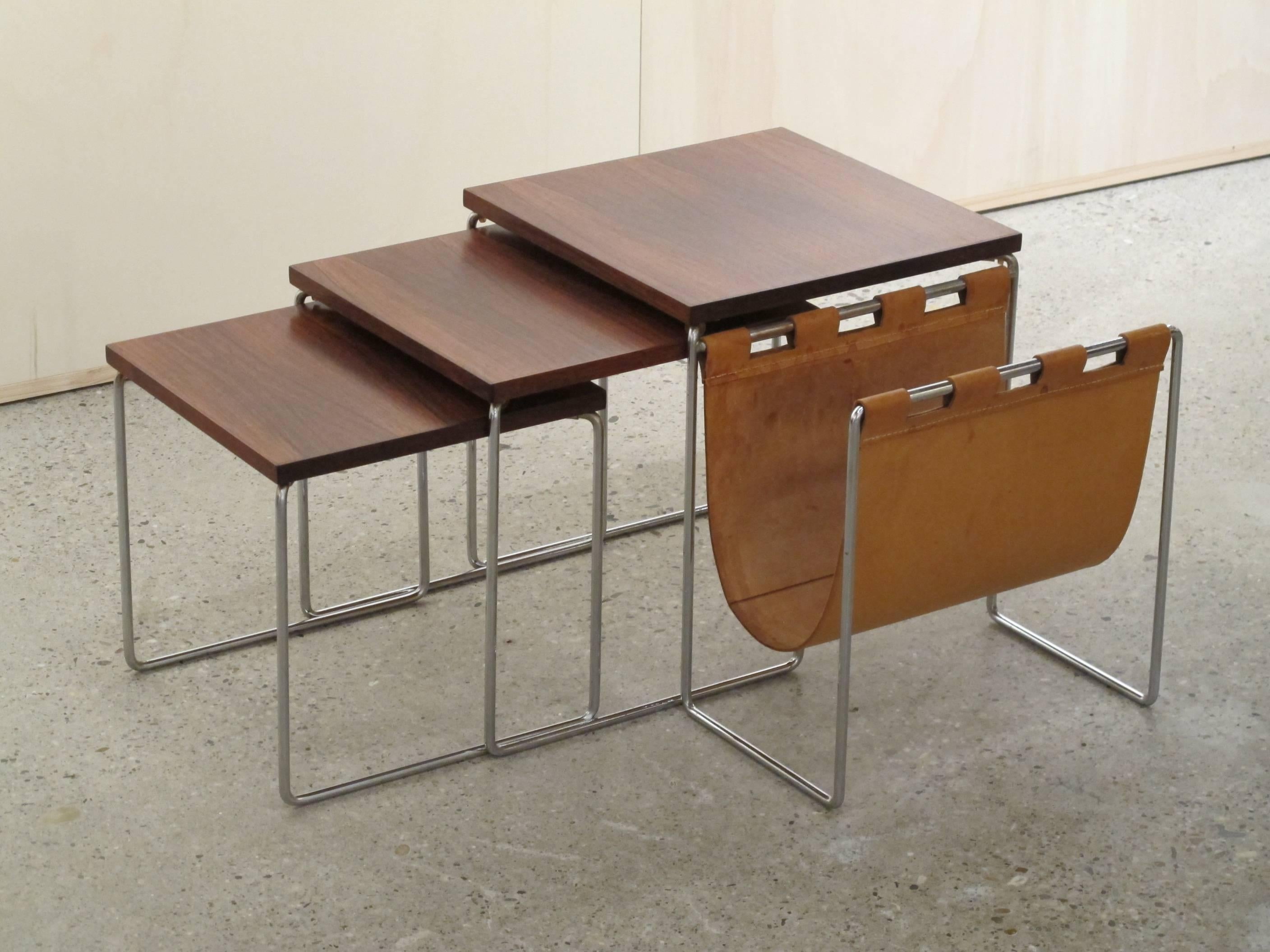 Set of vintage nesting tables with leather magazine rack and solid chromed frame.
Great rosewood veneer with beautiful continuous pattern over the three tables (see picture 3).

Measurements of the large table: 37H x 35 x 35 cm.
Measurements of