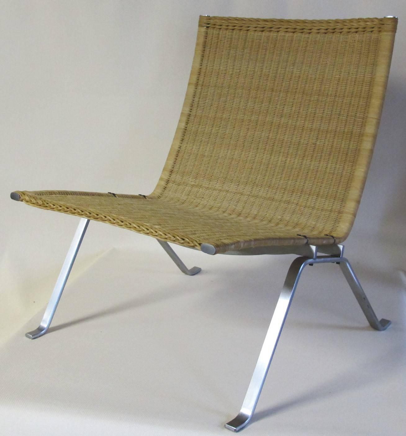 A beautiful stainless steel chair with a wickered seat, known as model PK22. Designed by Poul Kjaerholm and manufactured by Kold Christensen. This PK22 chair is marked with a stamp of the manufacturer and shows the magnificence of simplicity of