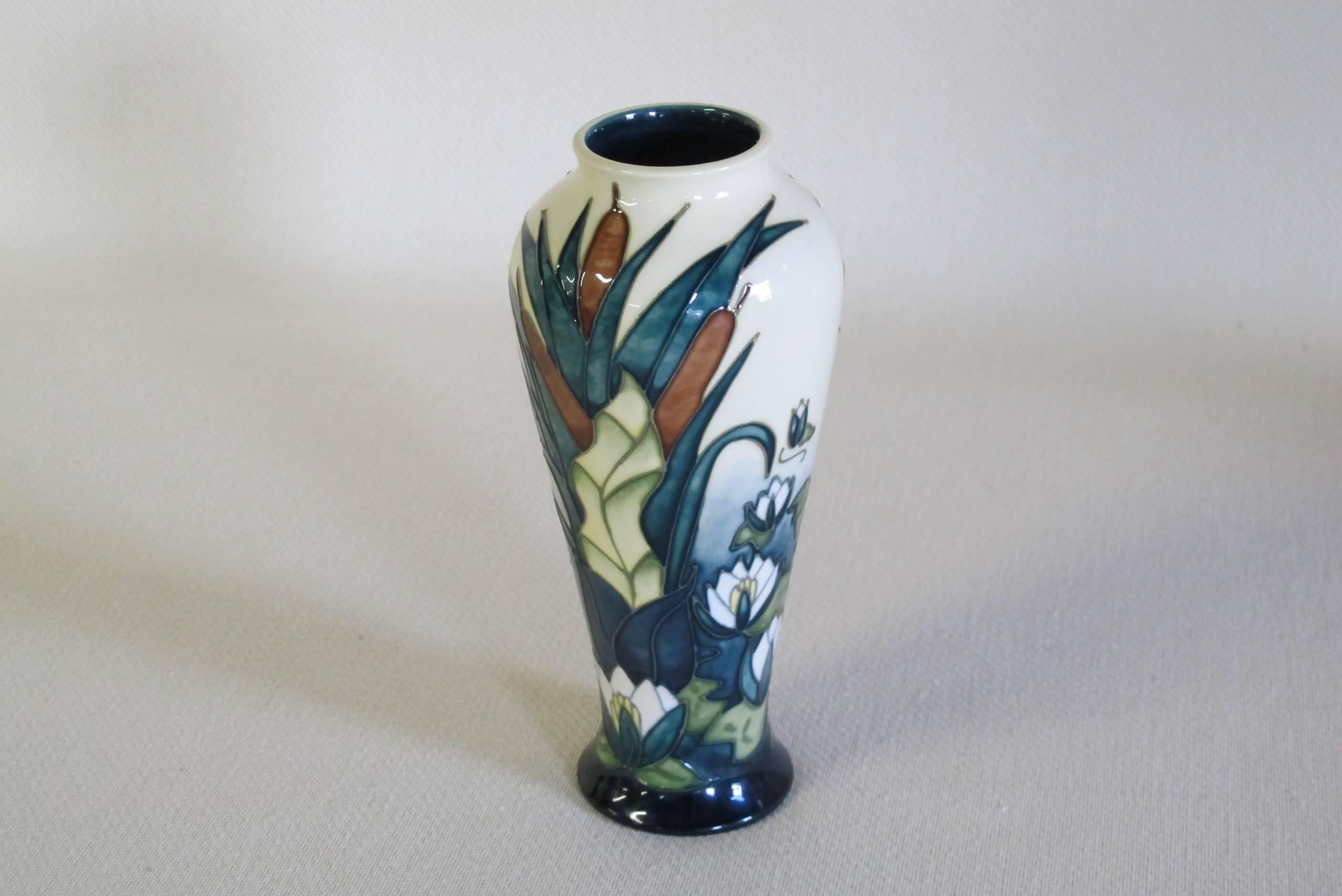 A beautiful ceramic vase from the Moorcroft pottery. The vase shows an overall decoration of a riverside with reeds and water lelies in true-to-life colors.

The Moorcroft pottery started in 1897 as a studio within a large ceramic company; James