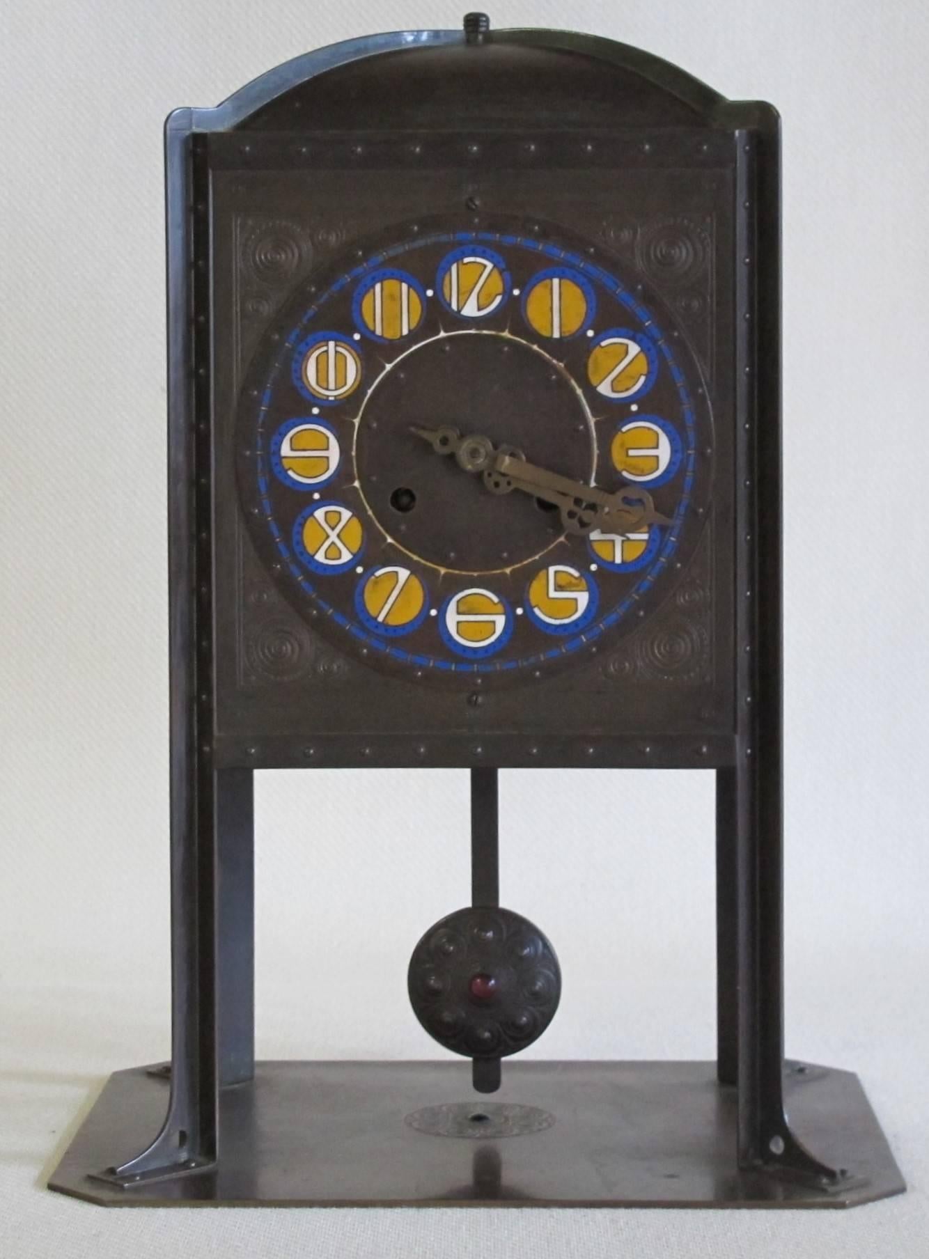 A beautiful Amsterdam School clock by Johannes Cornelis (J.C.) Stoffels and executed by Onder den Sint-Maarten, circa 1904. The pendulum consists of brass patinated. Among the pointers a tekst says: Time is money.