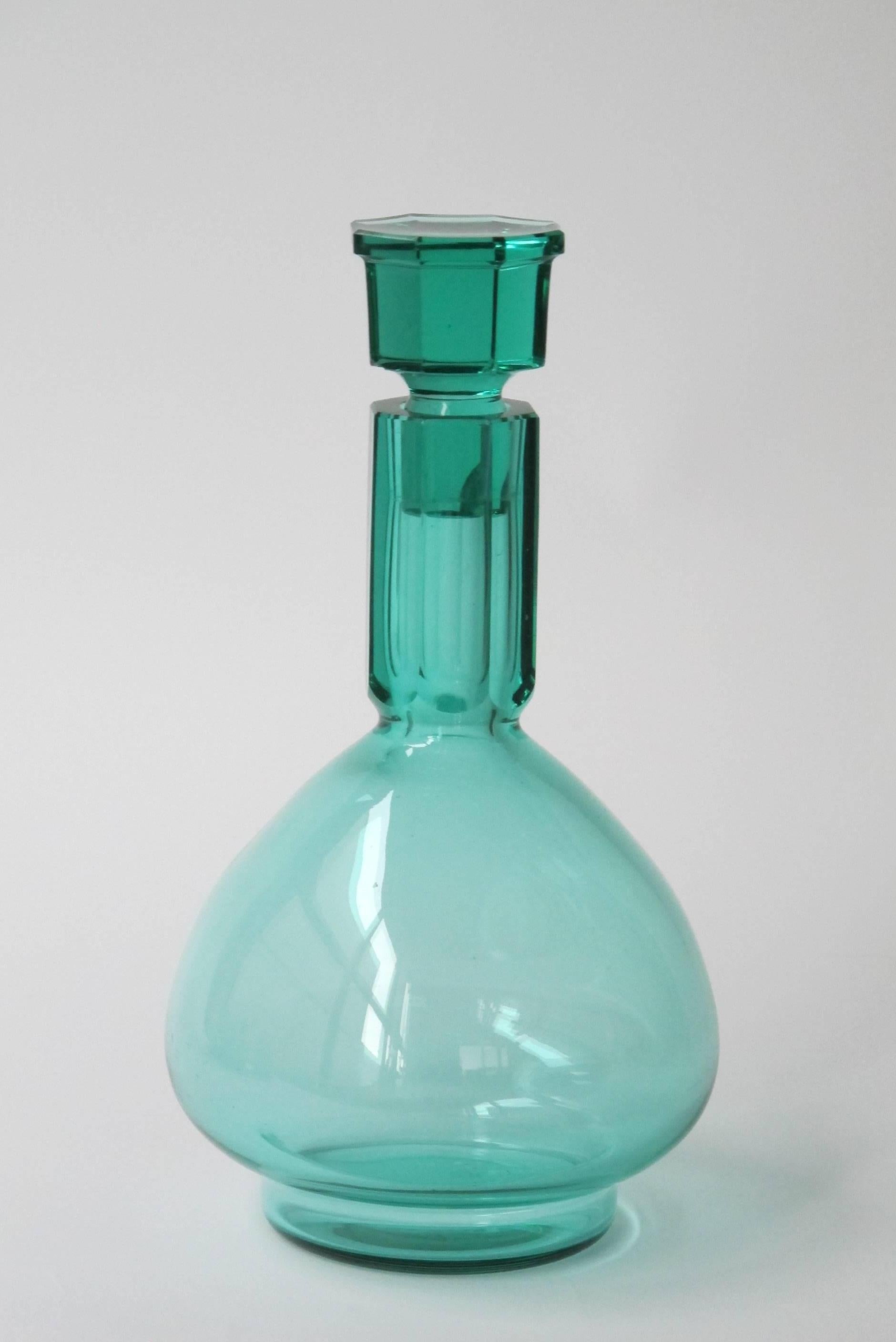 Beautiful sea-green whisky carafe set, designed by A.D. Copier for glass factory Leerdam in 1927. The offer includes a whisky carafe, six whisky beakers and a glass stand. 

The set has been collected over a couple of decades, with extreme