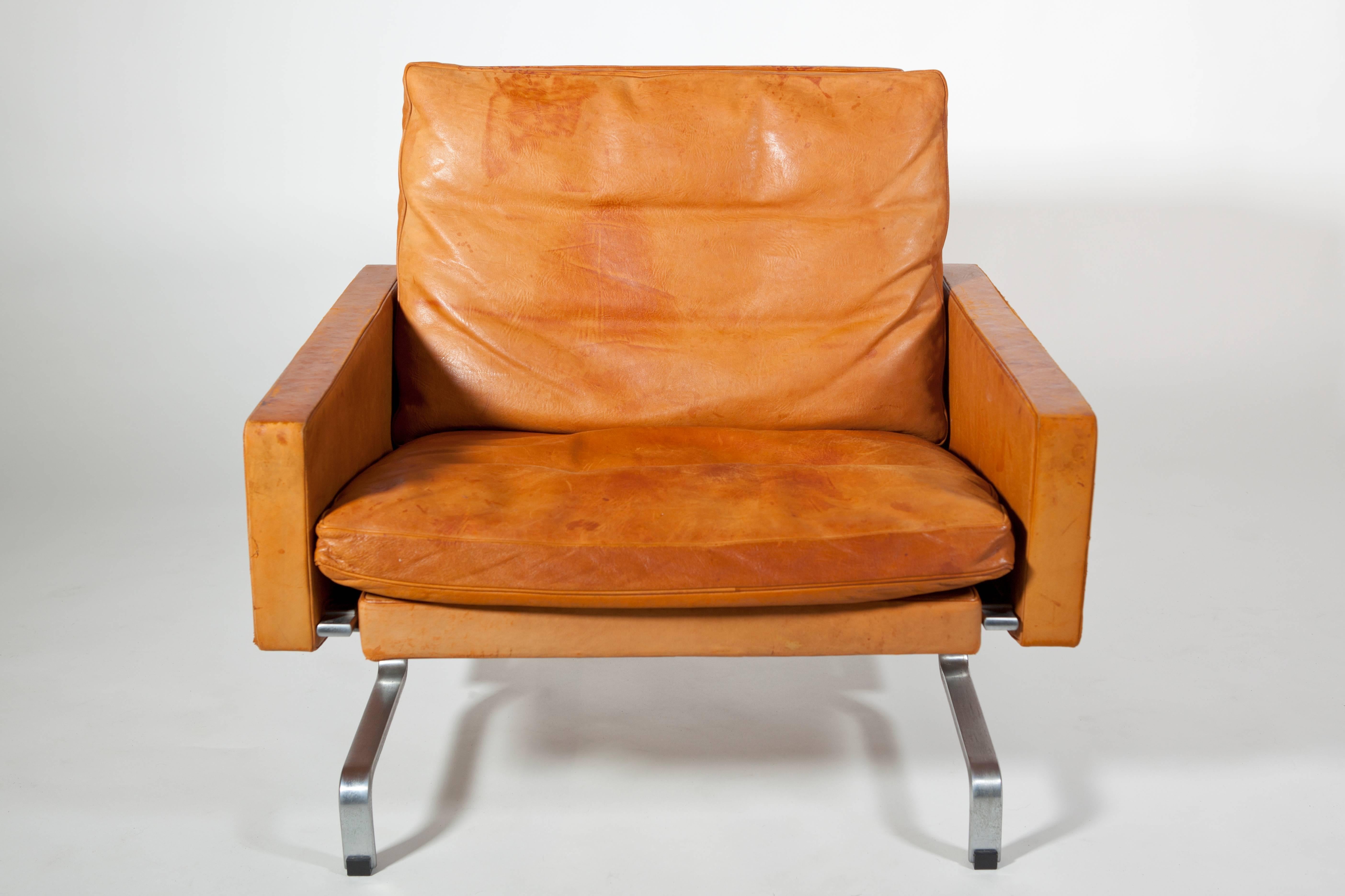 This vintage steel and leather chair, model PK31/1, is an early Industrial Design of Danish designer Poul Kjaerholm. This chair was part of the rare first series produced by E. Kold Christensen, shortly after 1958. The chair has been used as it was