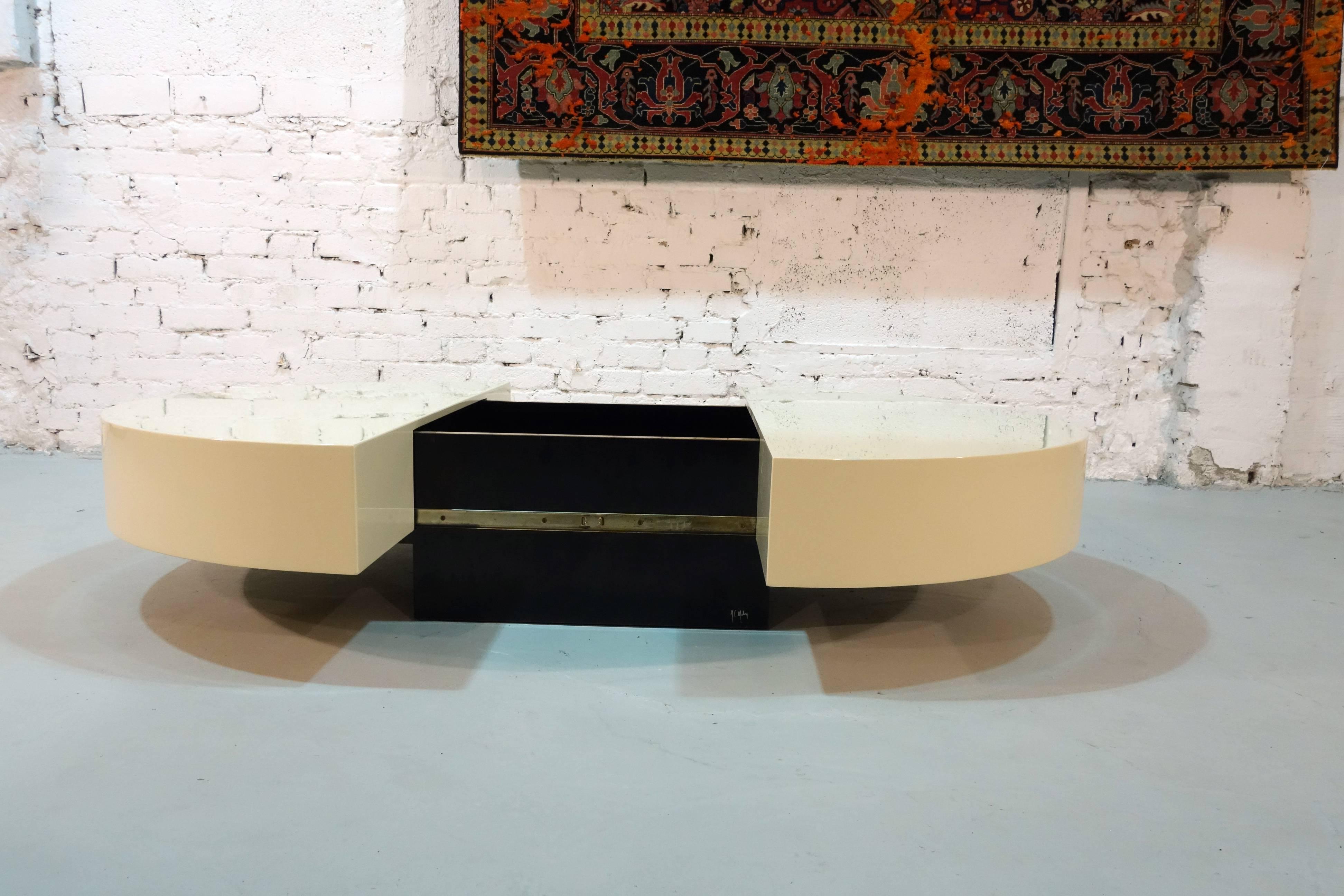 Signed coffee table by Jean Claude Mahey and with a hidden inner bar storage section.