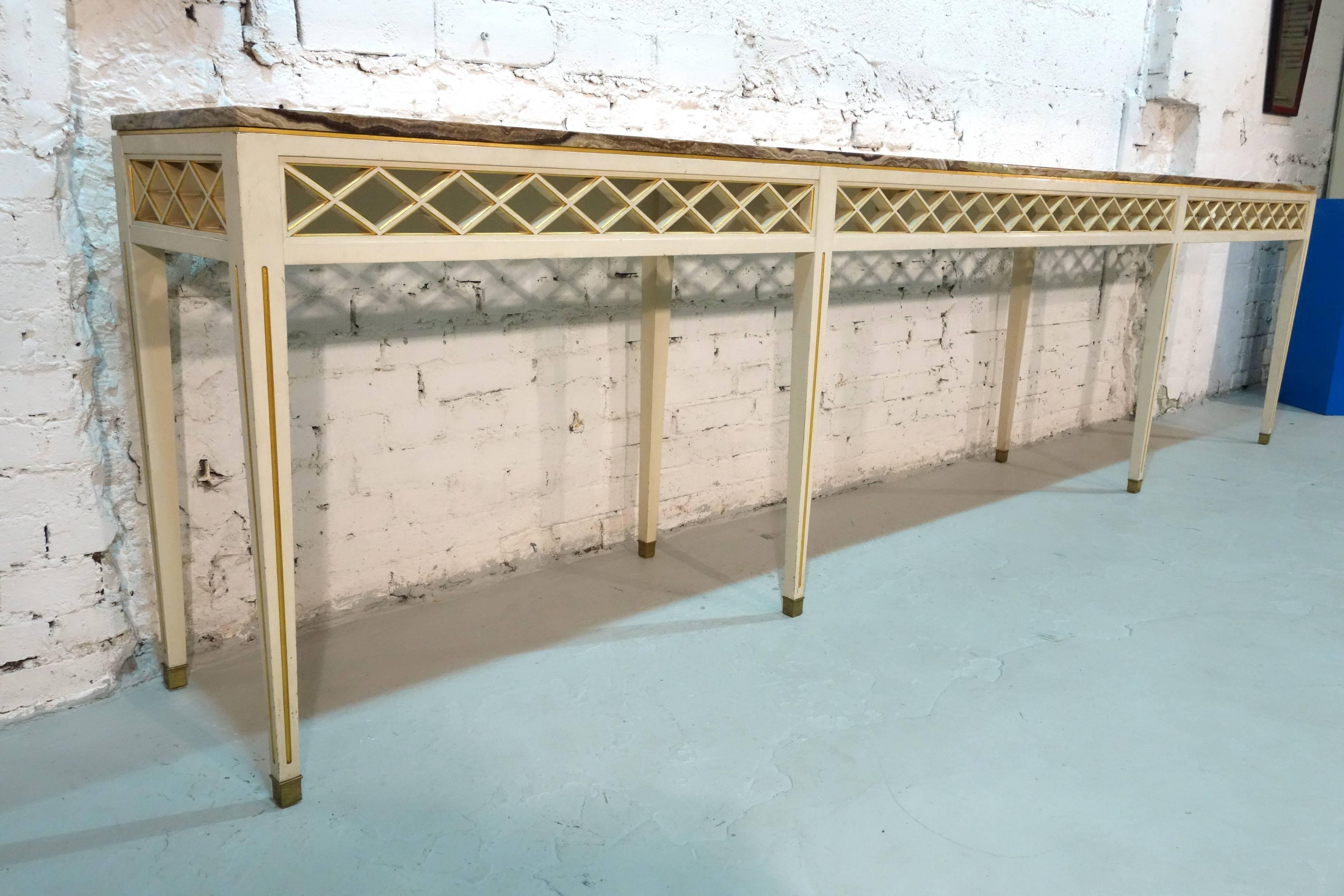 A console table designed for Bellevue Palace in Berlin by Carl-Heinz Schwennicke in 1958. Made of lacquered and giltwood, the top is comprised of five onyx slabs. This design shows inspiration by German neoclassicism as well as Maison Jansen.
