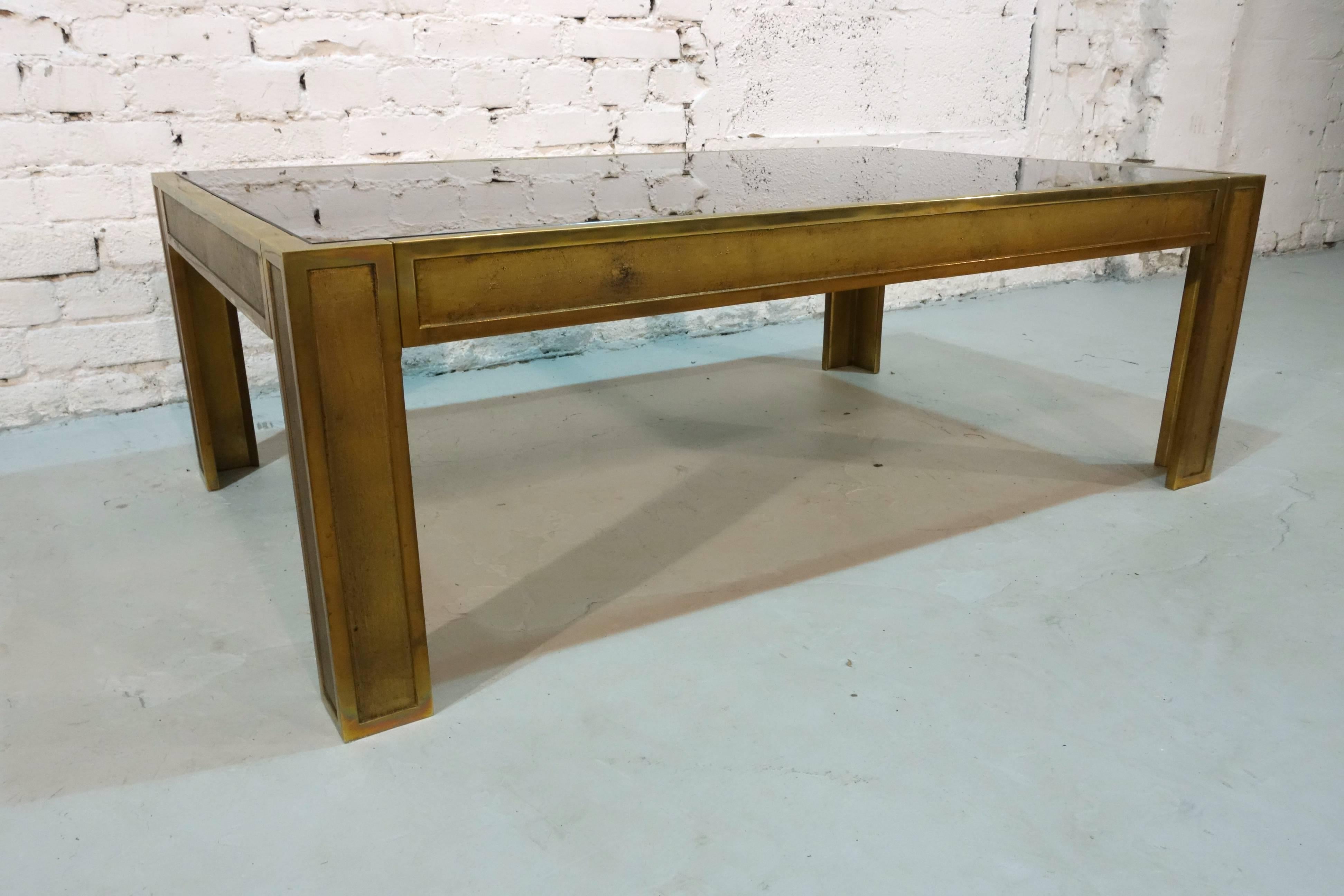 Heavy bronze coffee table with smoked glass plate.